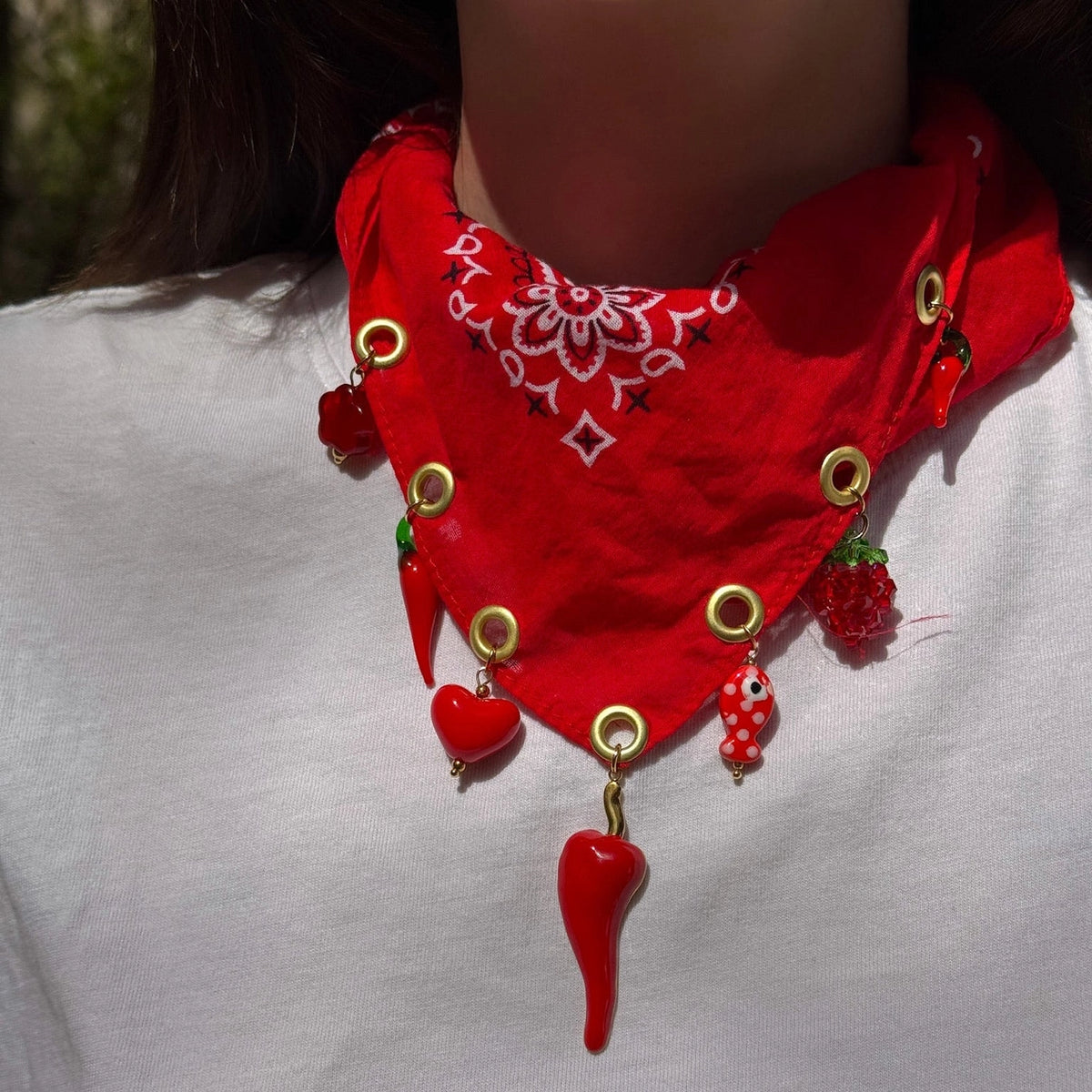 Red bandana with decorative elements on a white background