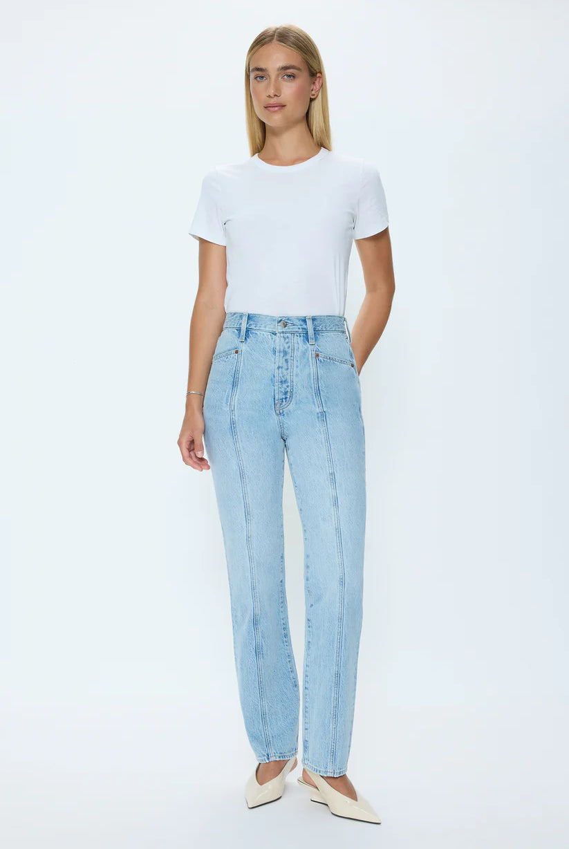 Woman wearing a white t-shirt and light blue jeans on a white background