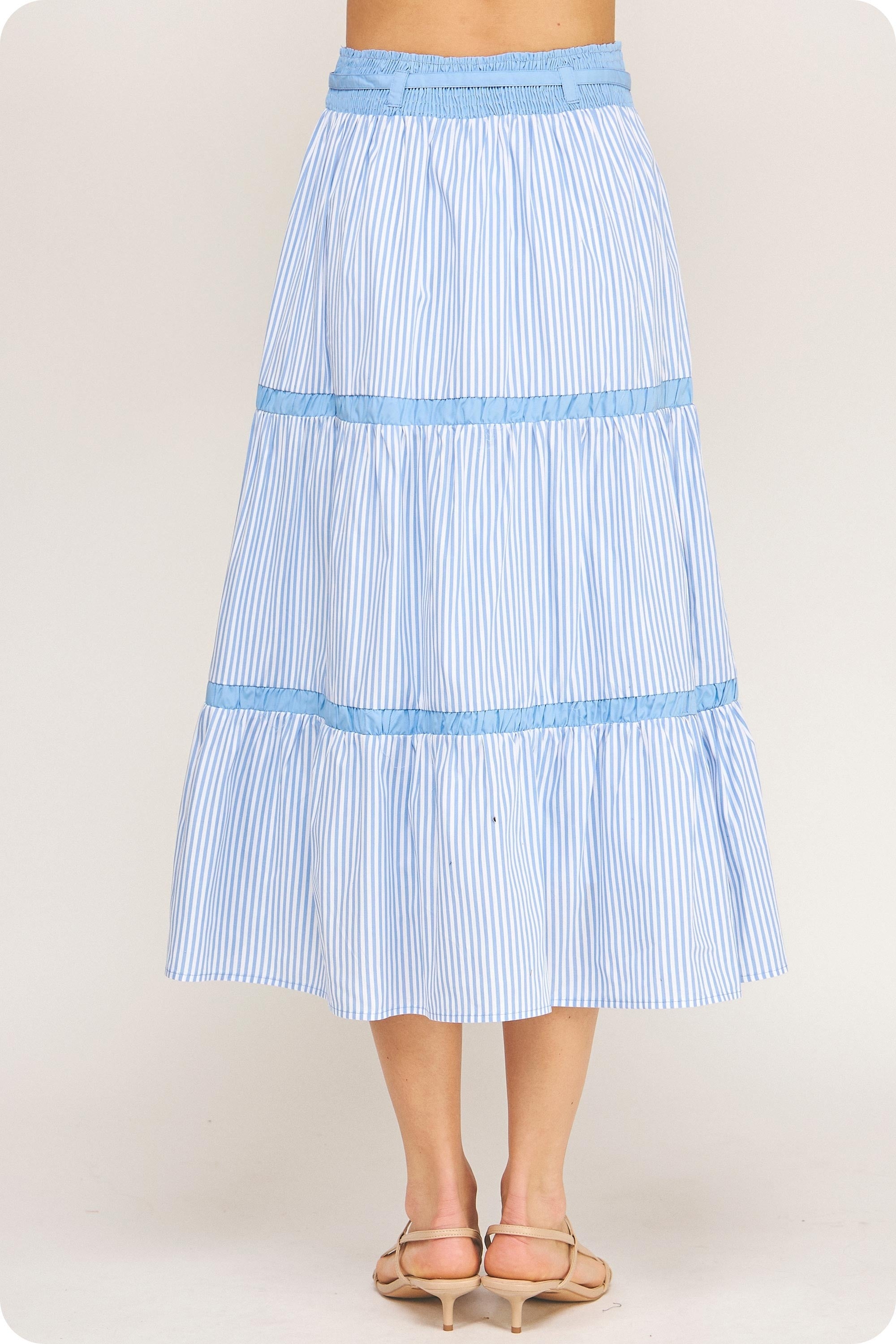 Light blue striped skirt worn by a person on a plain background