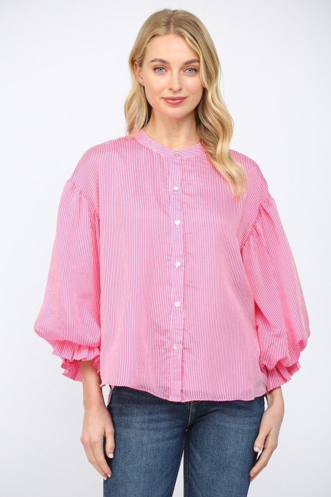 Woman wearing a pink striped blouse with balloon sleeves on a white background