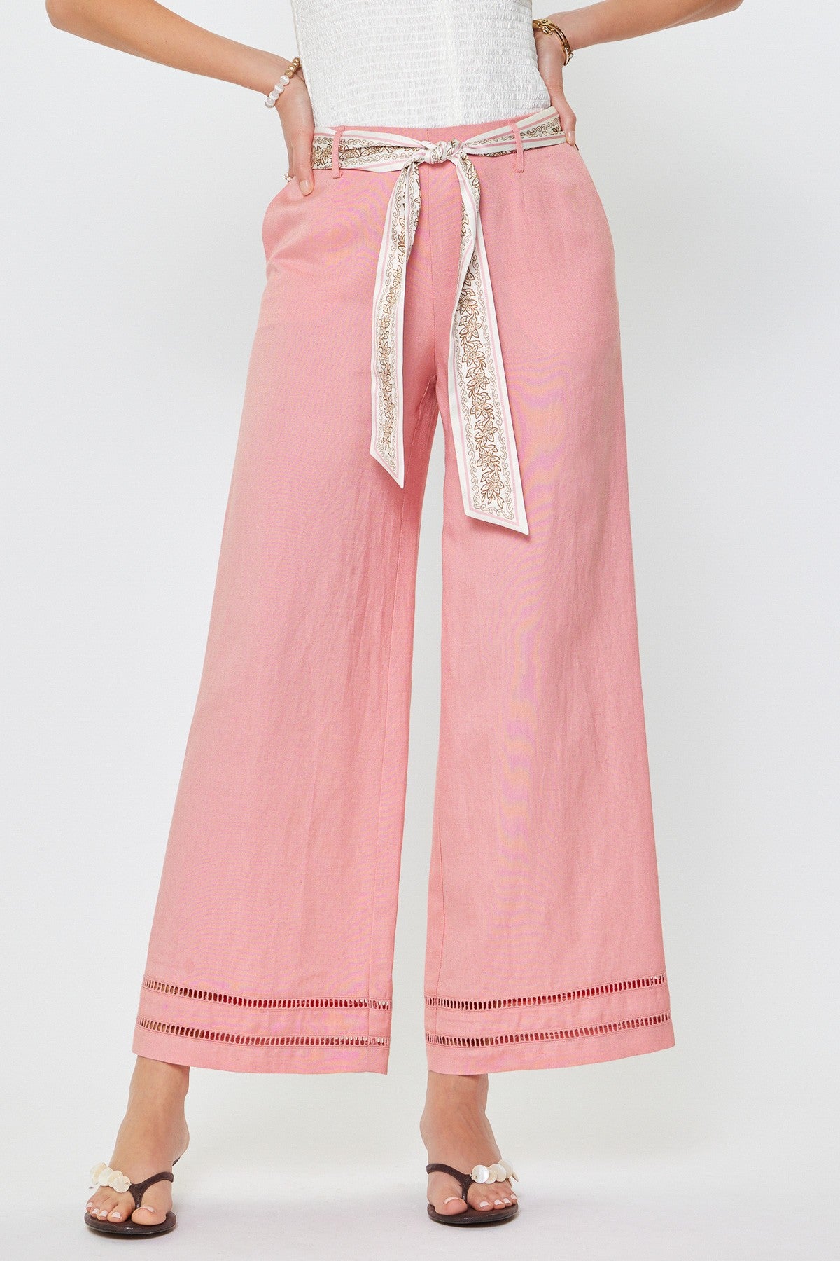 Pink pants with a decorative belt on a white background