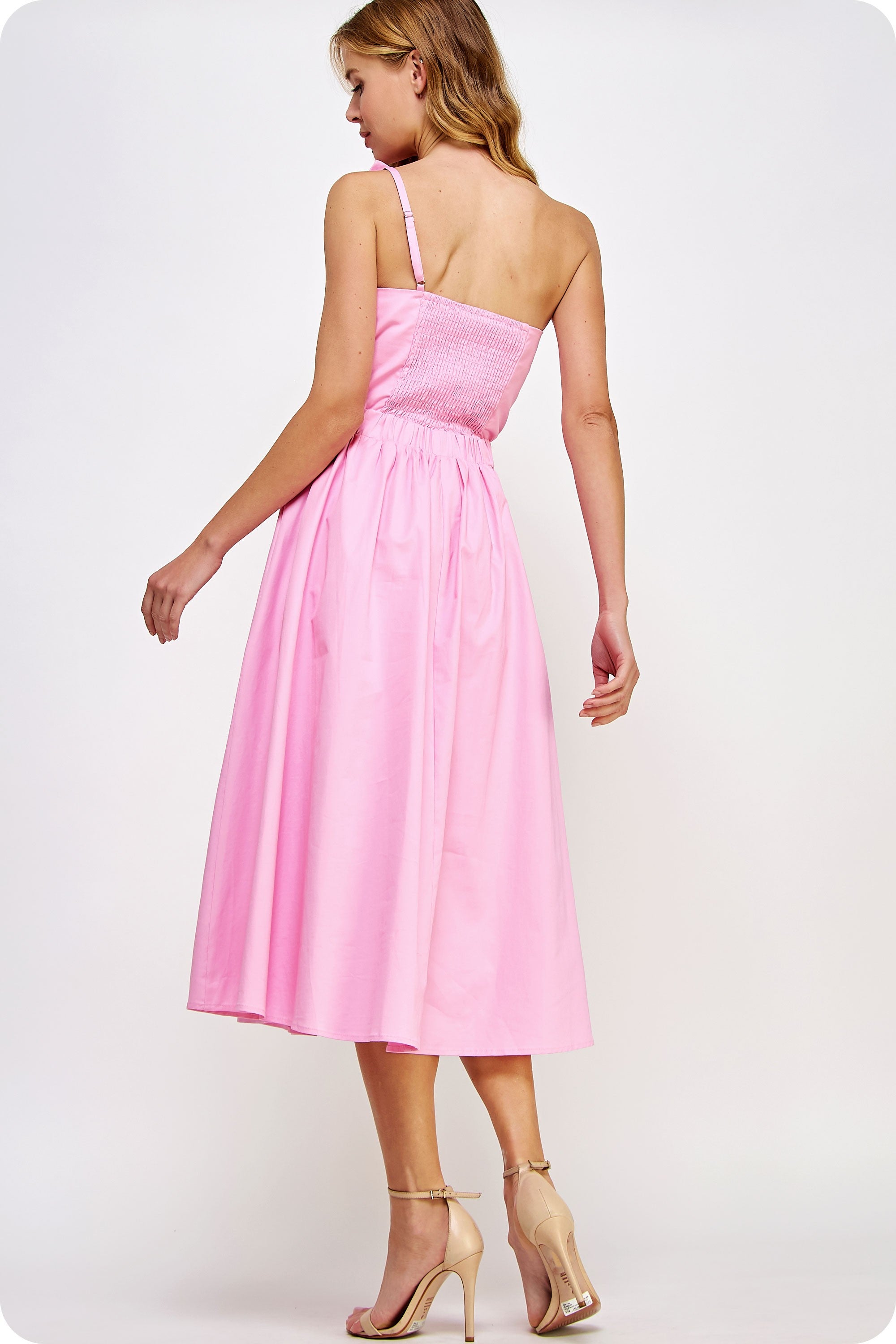 Woman wearing a pink dress on a white background