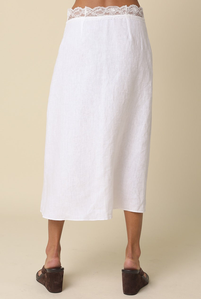 White skirt with lace waistband on a beige background