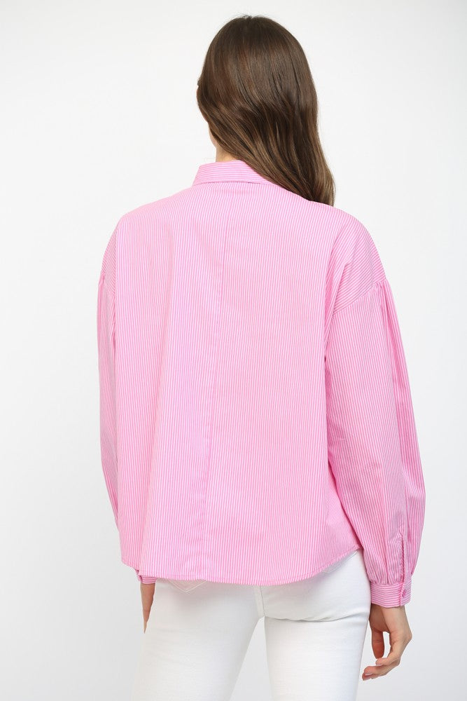 Person wearing a pink shirt on a white background
