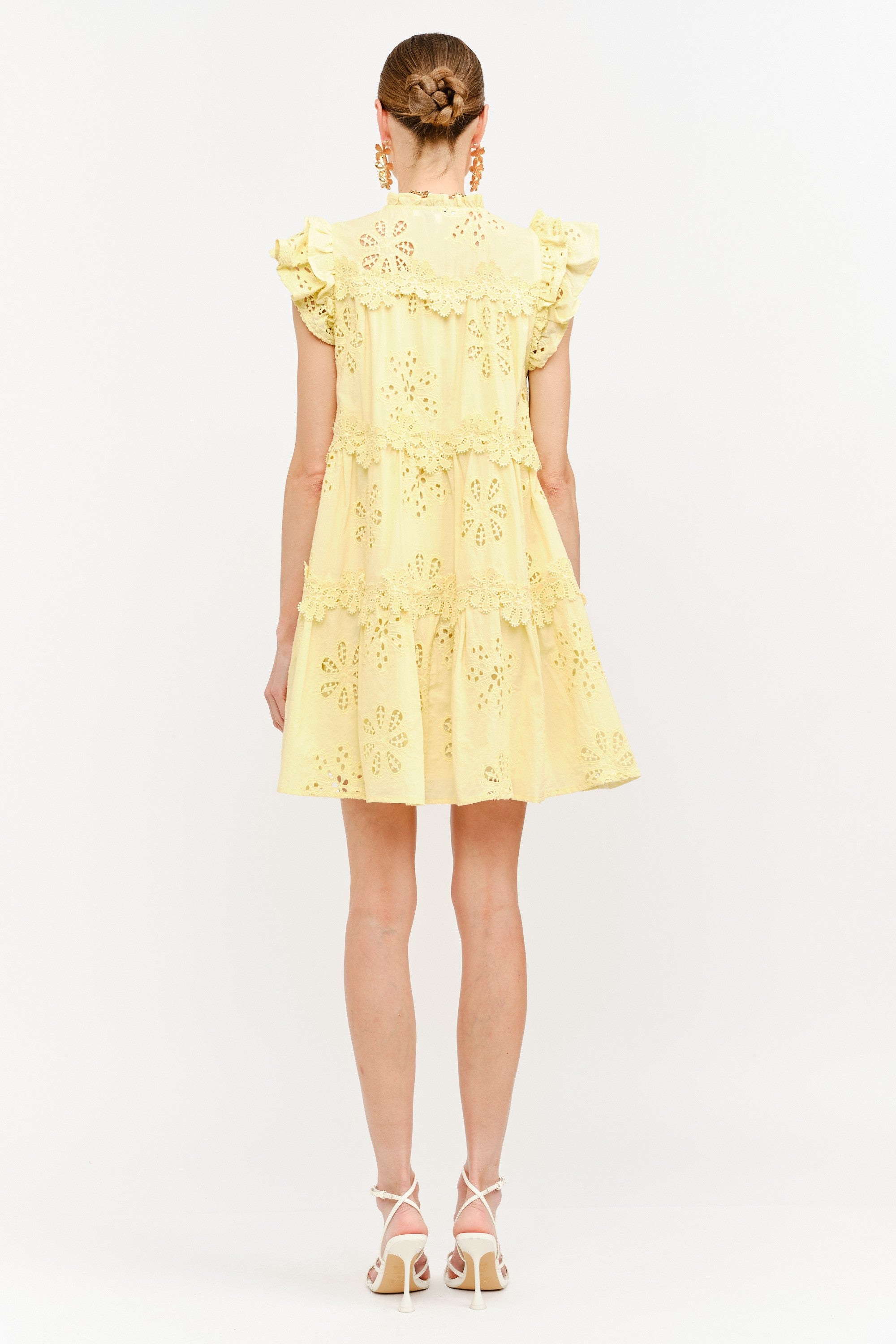 Yellow dress with floral embroidery on a white background