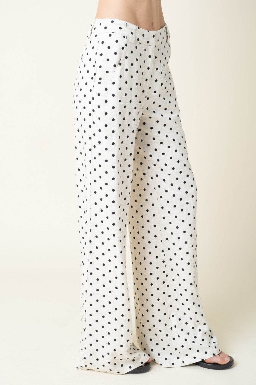White pants with black polka dots on a white background