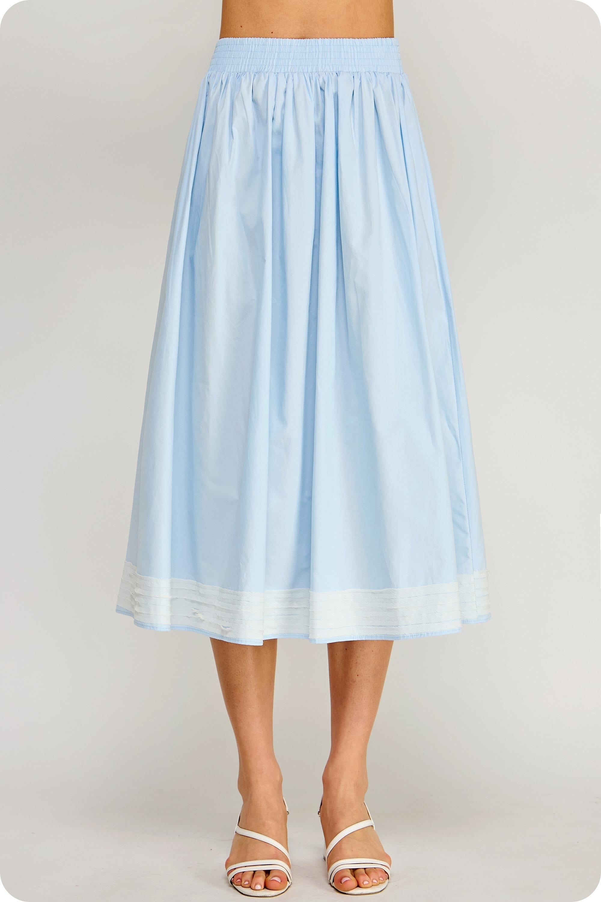 Light blue skirt worn by a person on a plain background