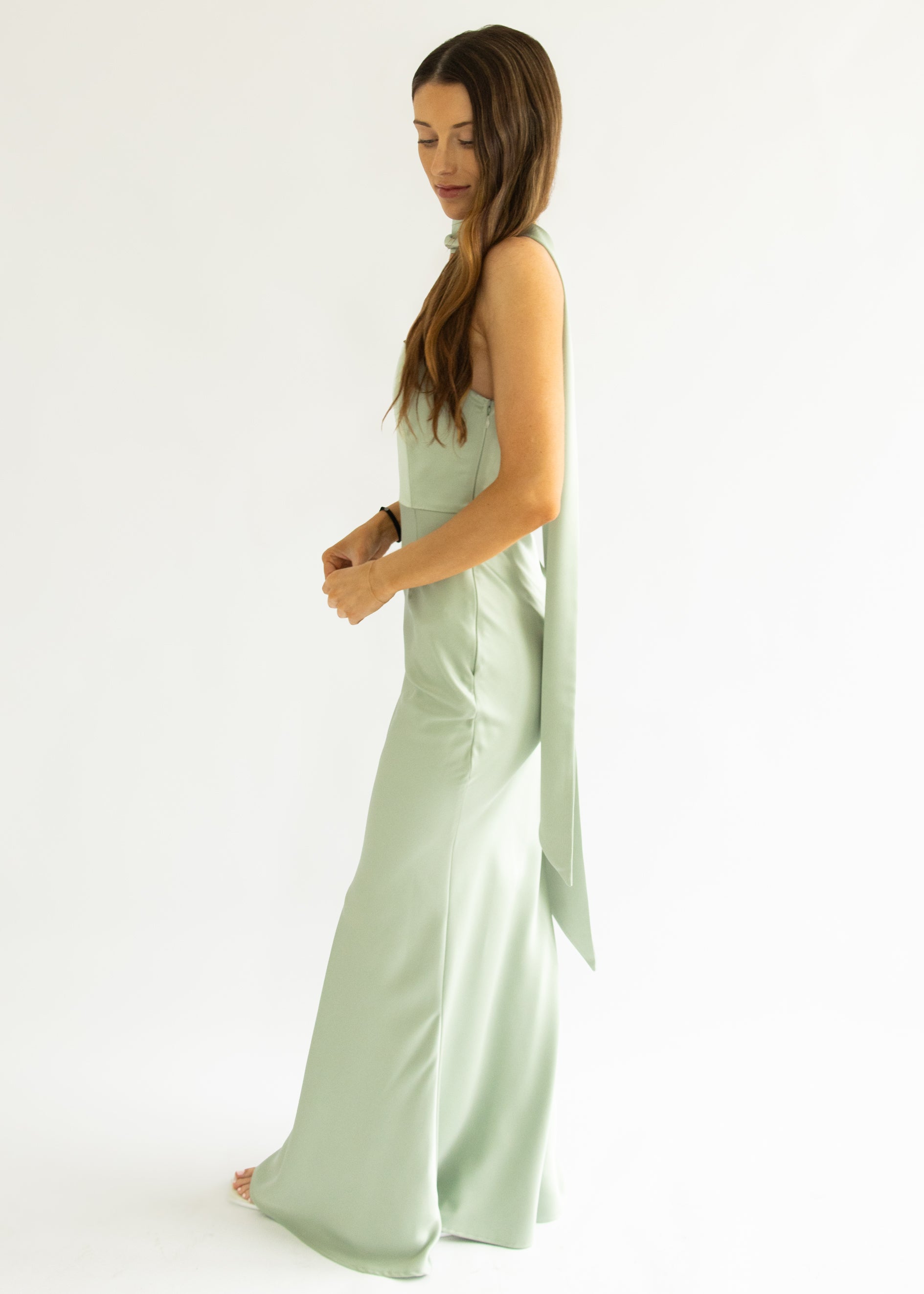 Woman wearing a light green dress with a white background
