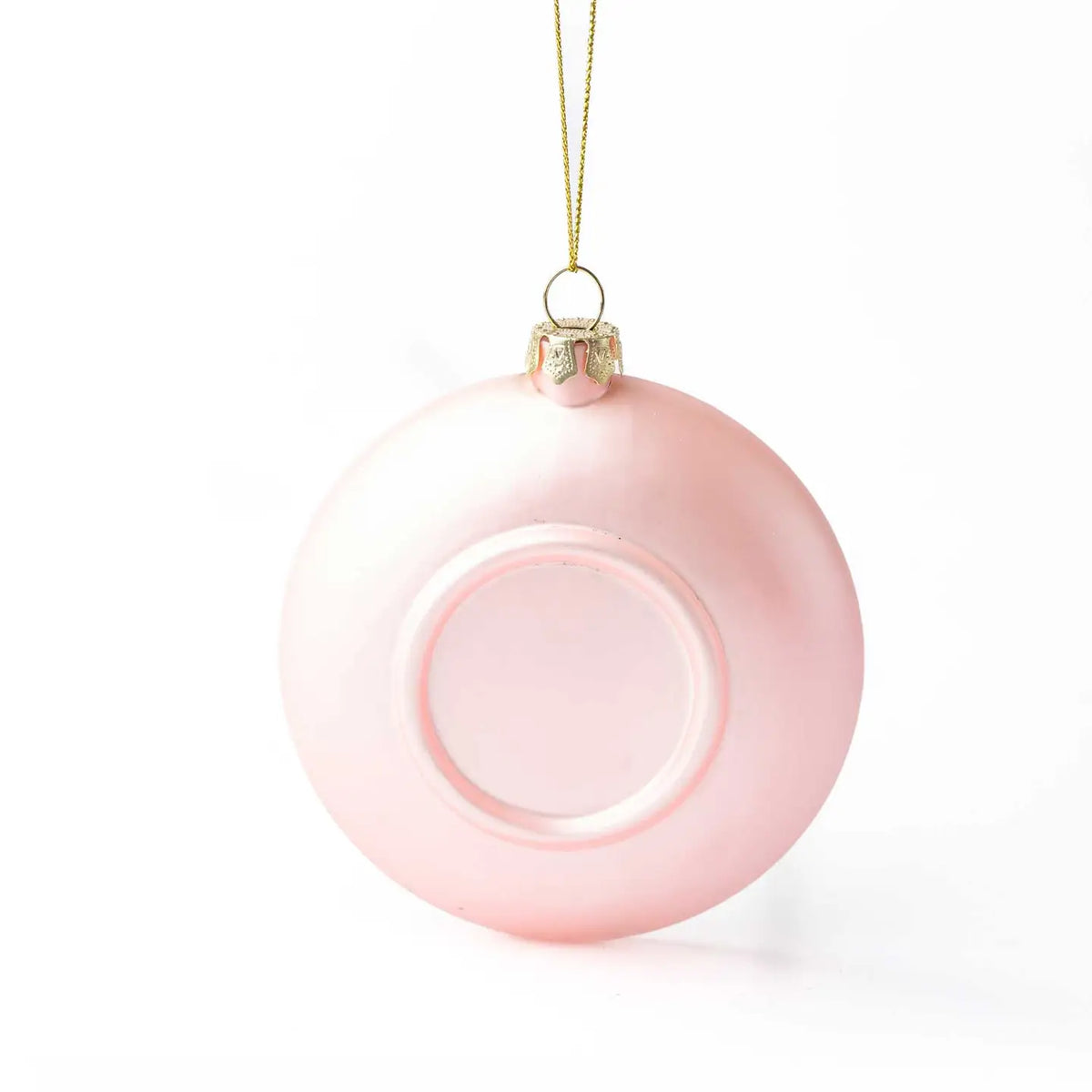 Pink Christmas ornament with gold chain on a white background