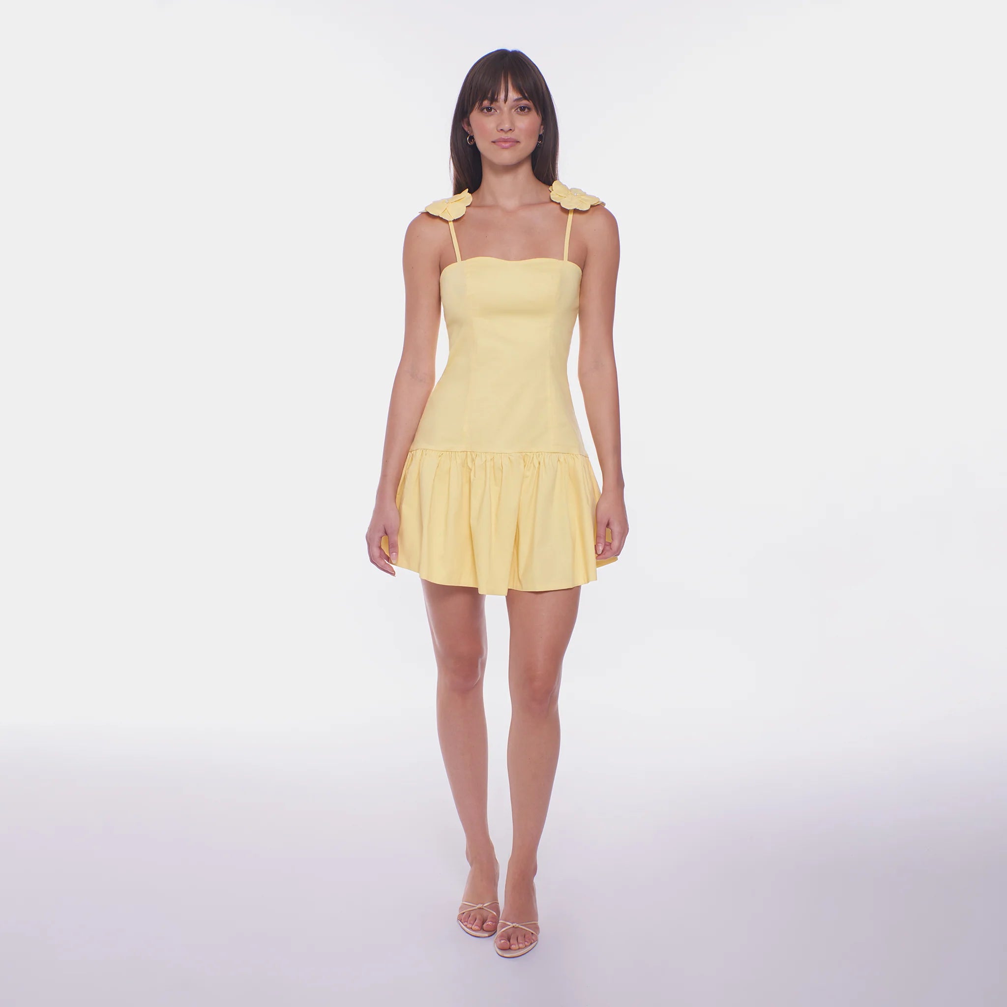 Woman wearing a yellow dress on a white background