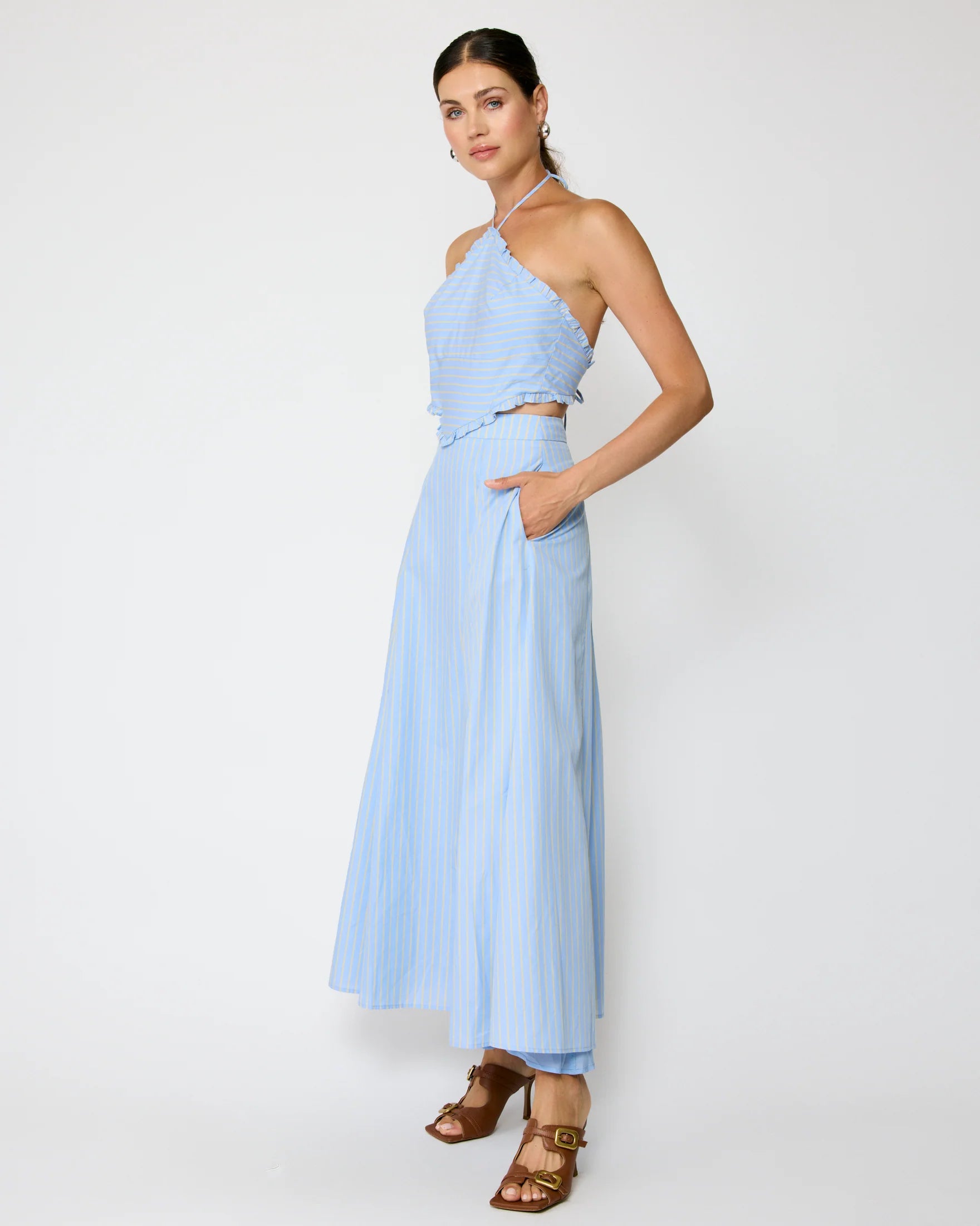 Woman wearing a light blue one-shoulder dress on a white background