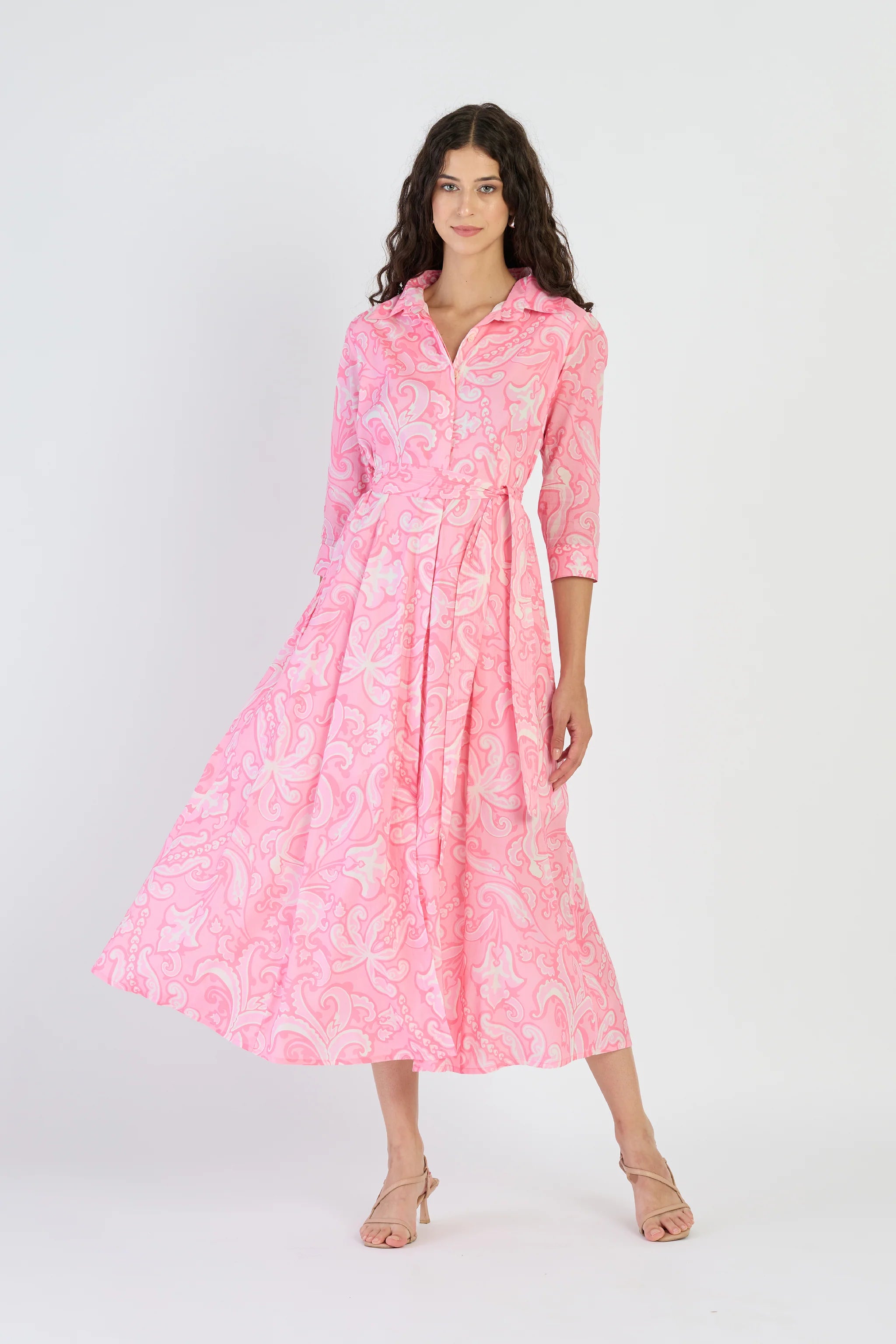 Woman wearing a pink dress with a white background