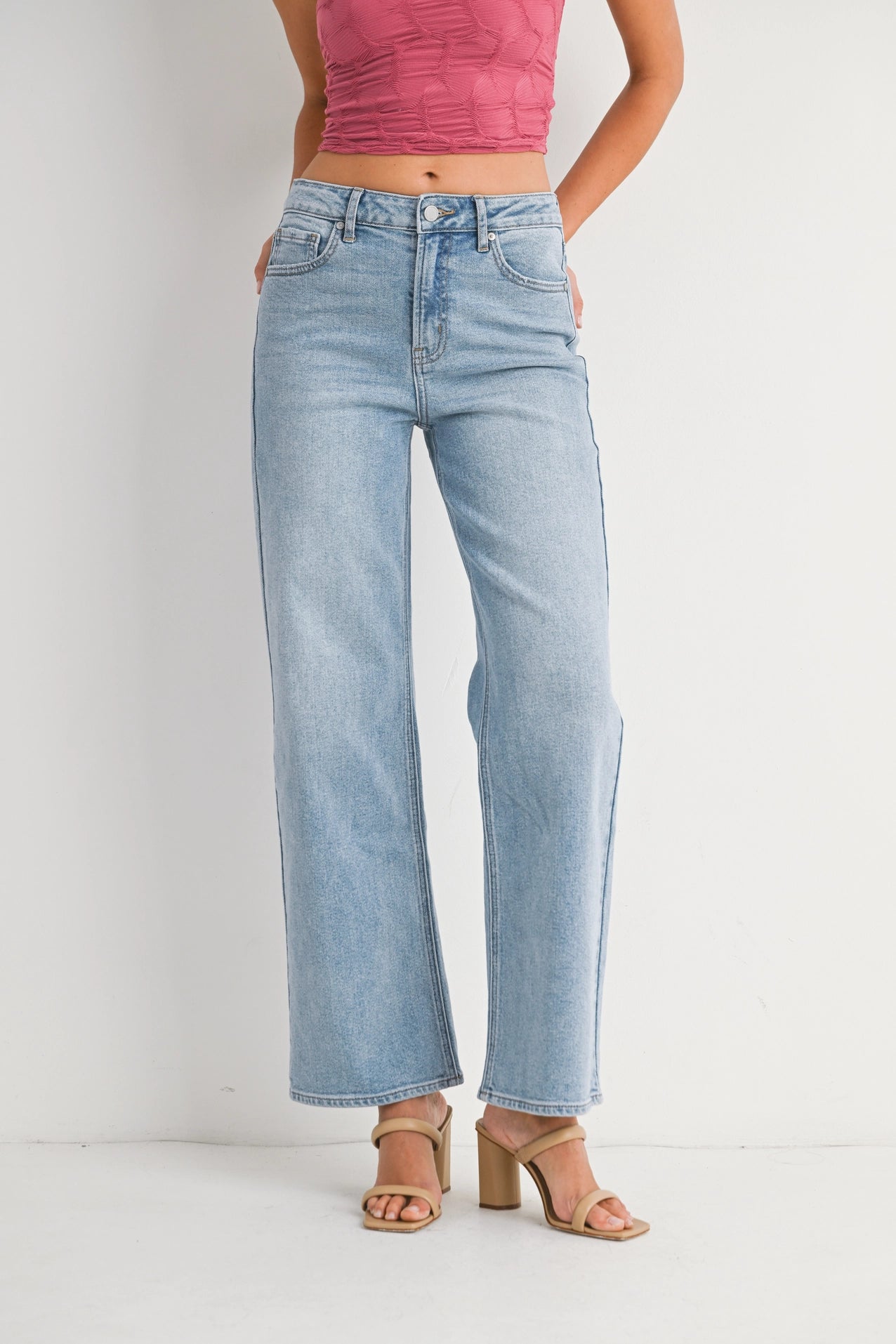 Light blue jeans worn by a person on a white background