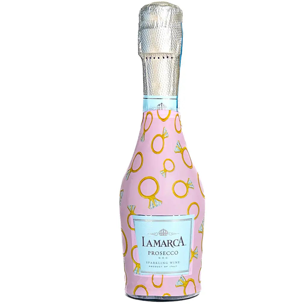 Pink bottle of Lamarca Prosecco with gold ring pattern on a pink background