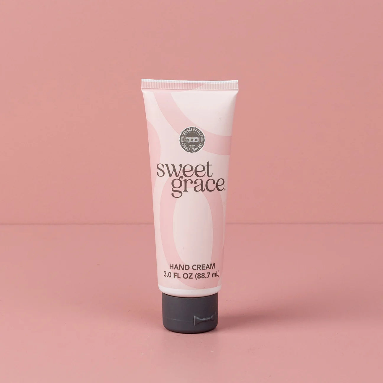 Tube of sweet grace hand cream on a pink background