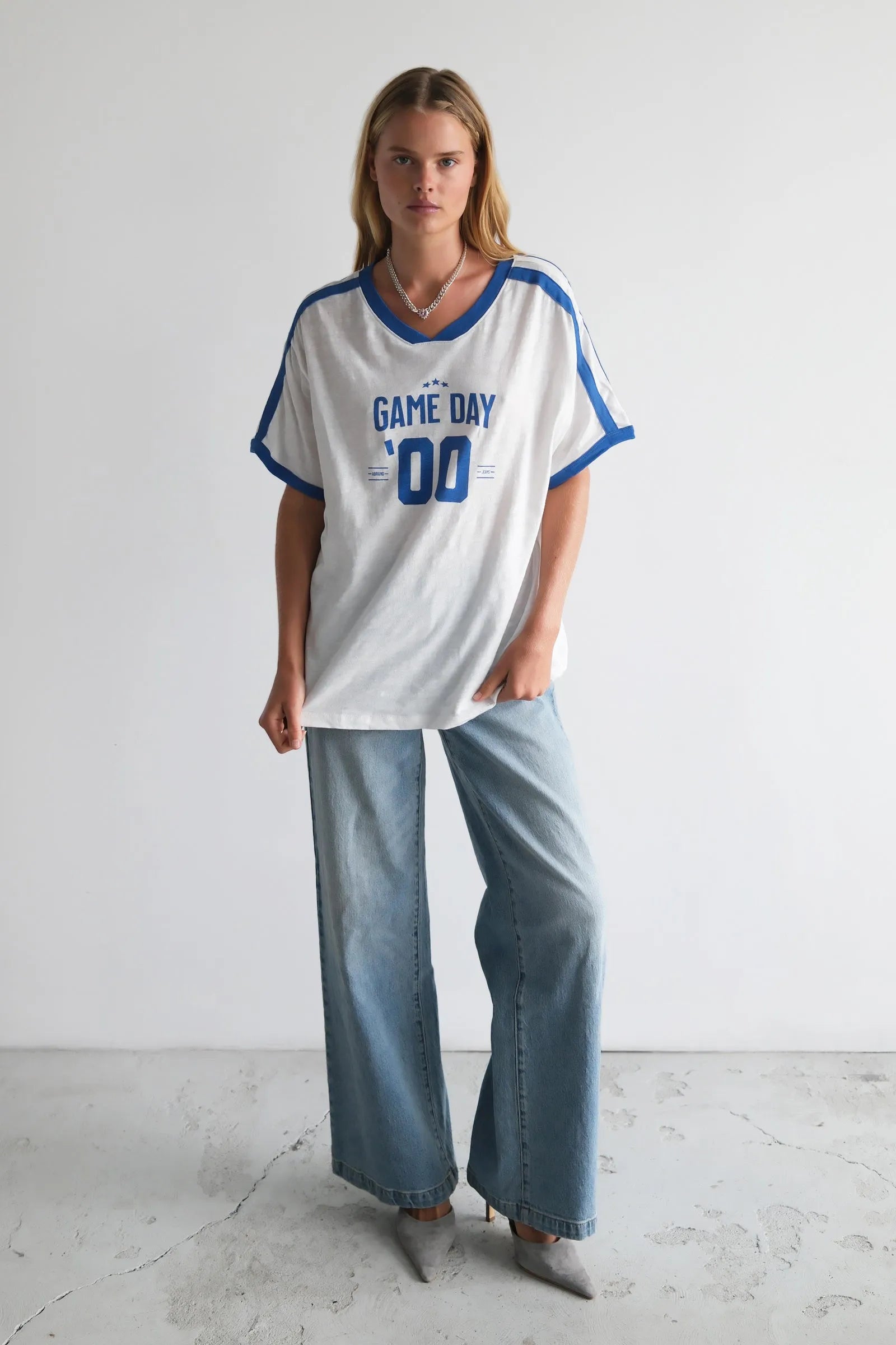 Person wearing a 'Game Day' t-shirt with blue accents on a white background