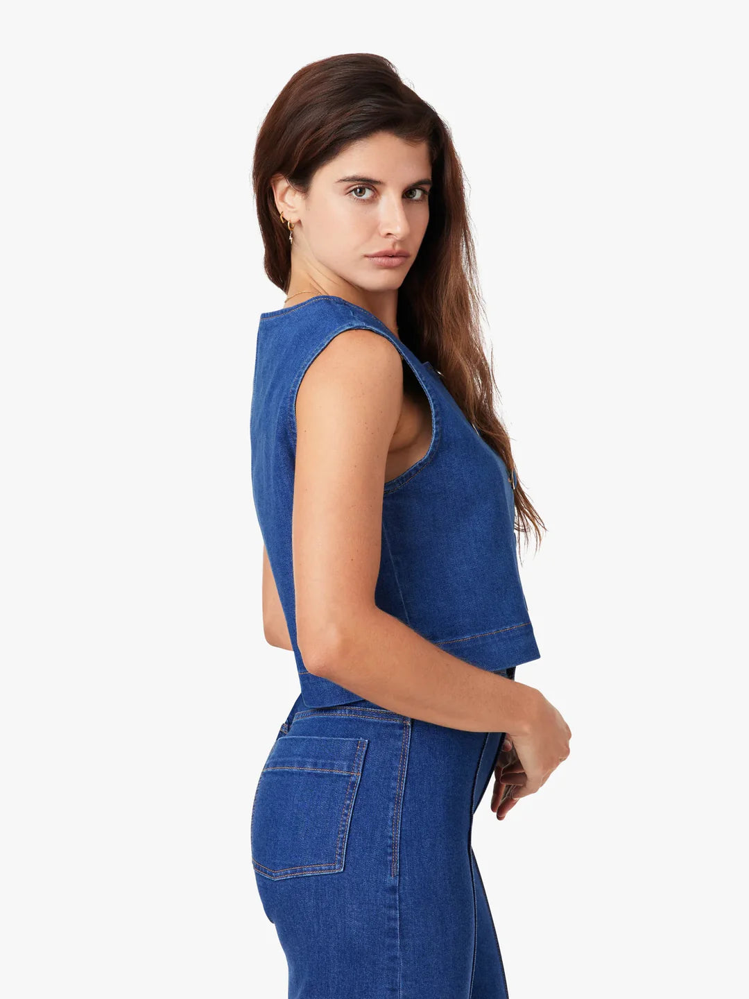 Woman wearing a blue denim dress on a white background