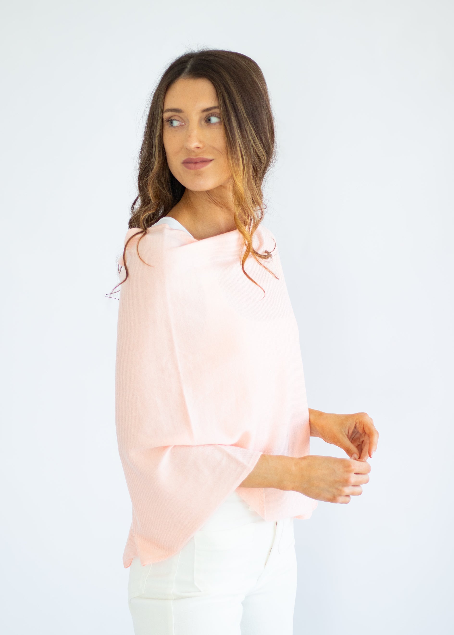 Woman wearing a light pink blouse against a white background