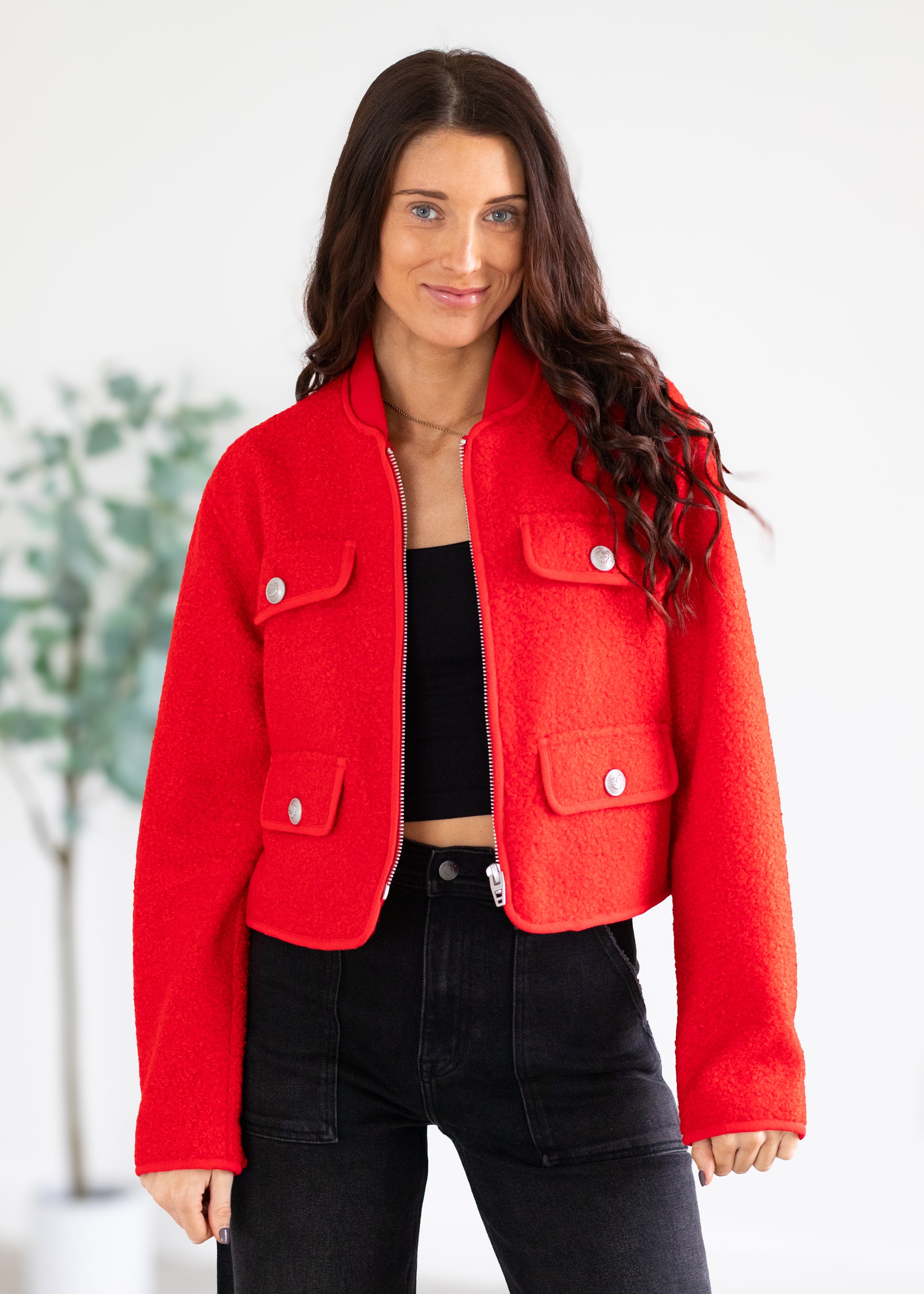 Woman wearing a red jacket with a blurred background