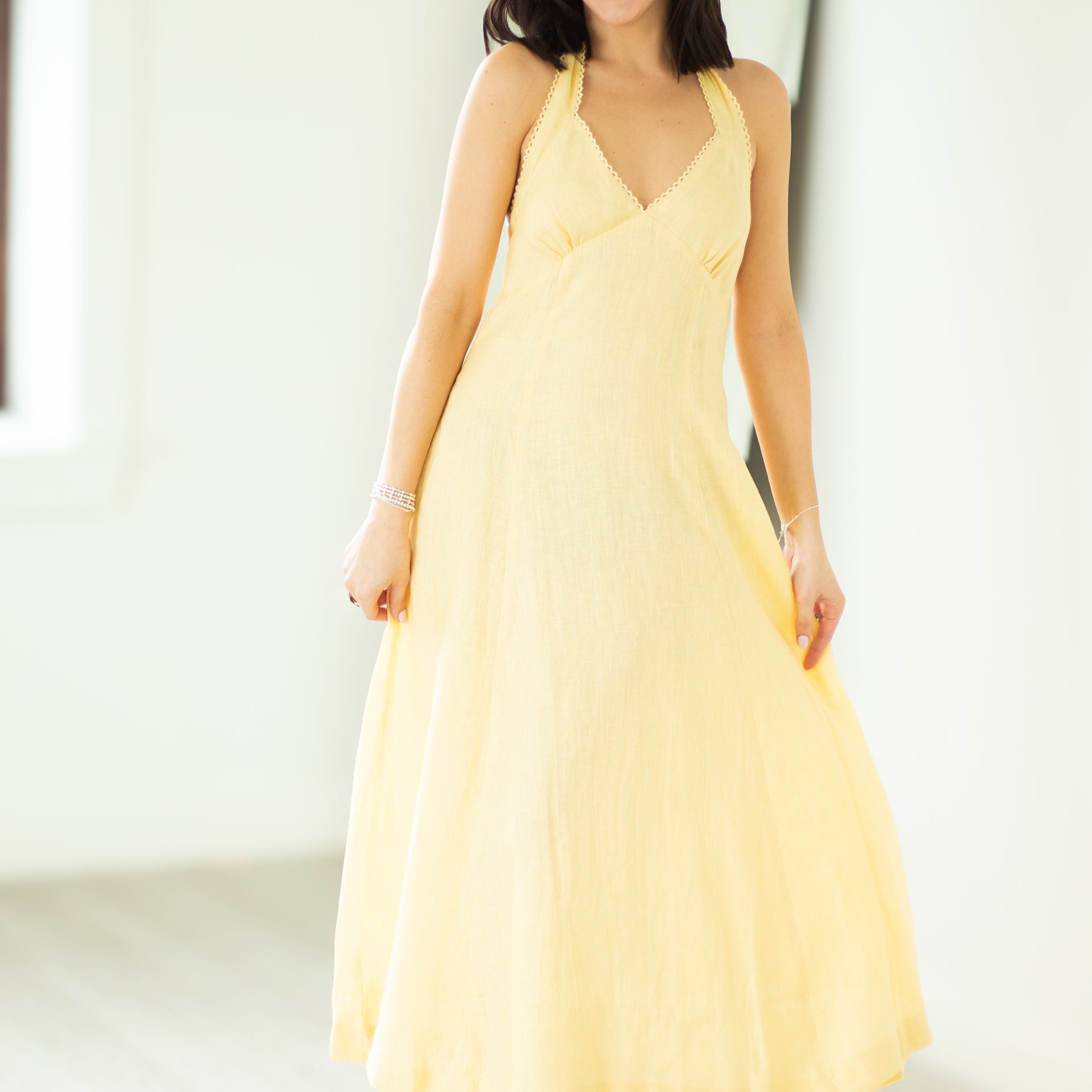 Woman wearing a yellow dress against a white background