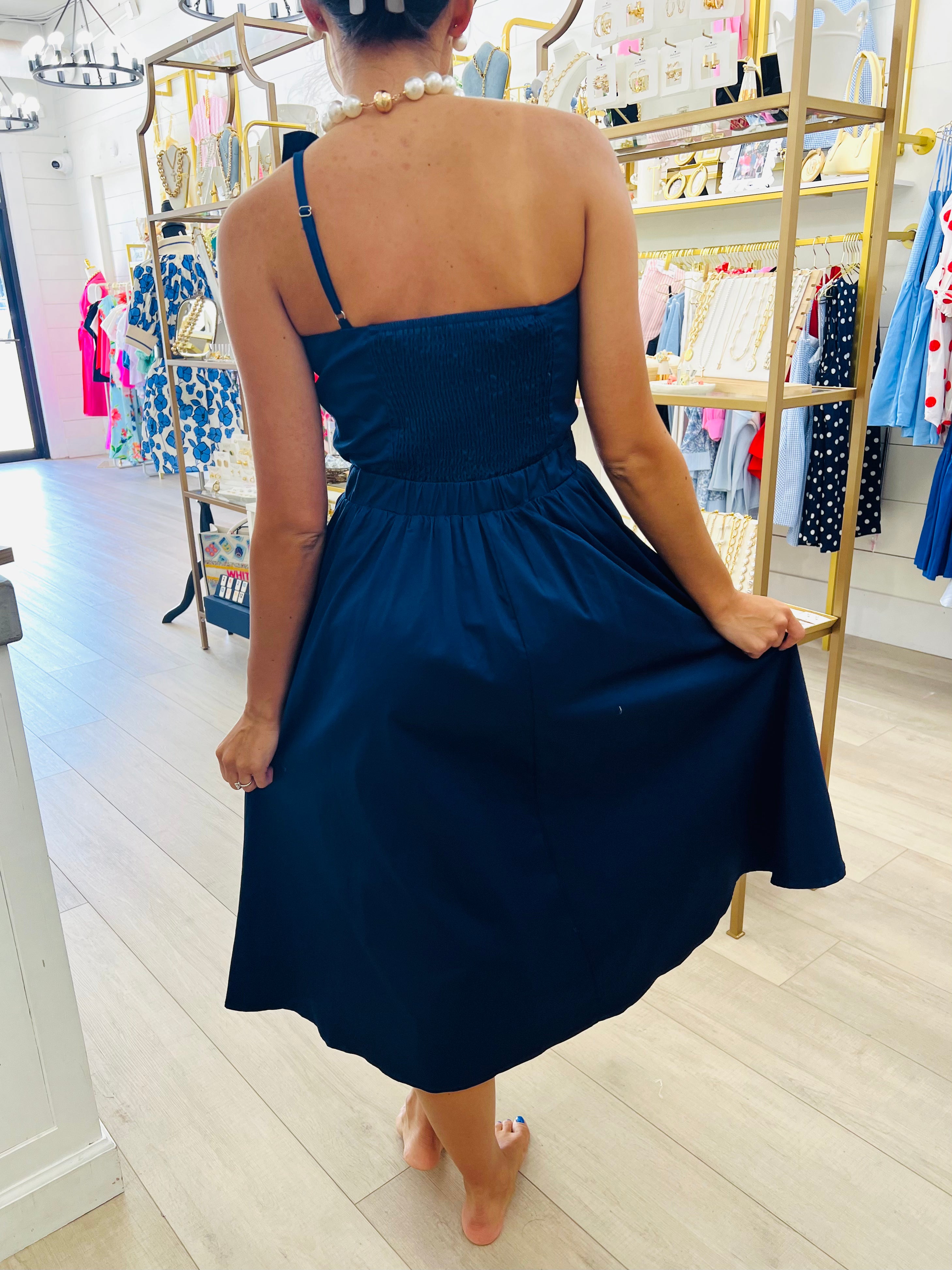 Woman wearing a blue dress in a store setting