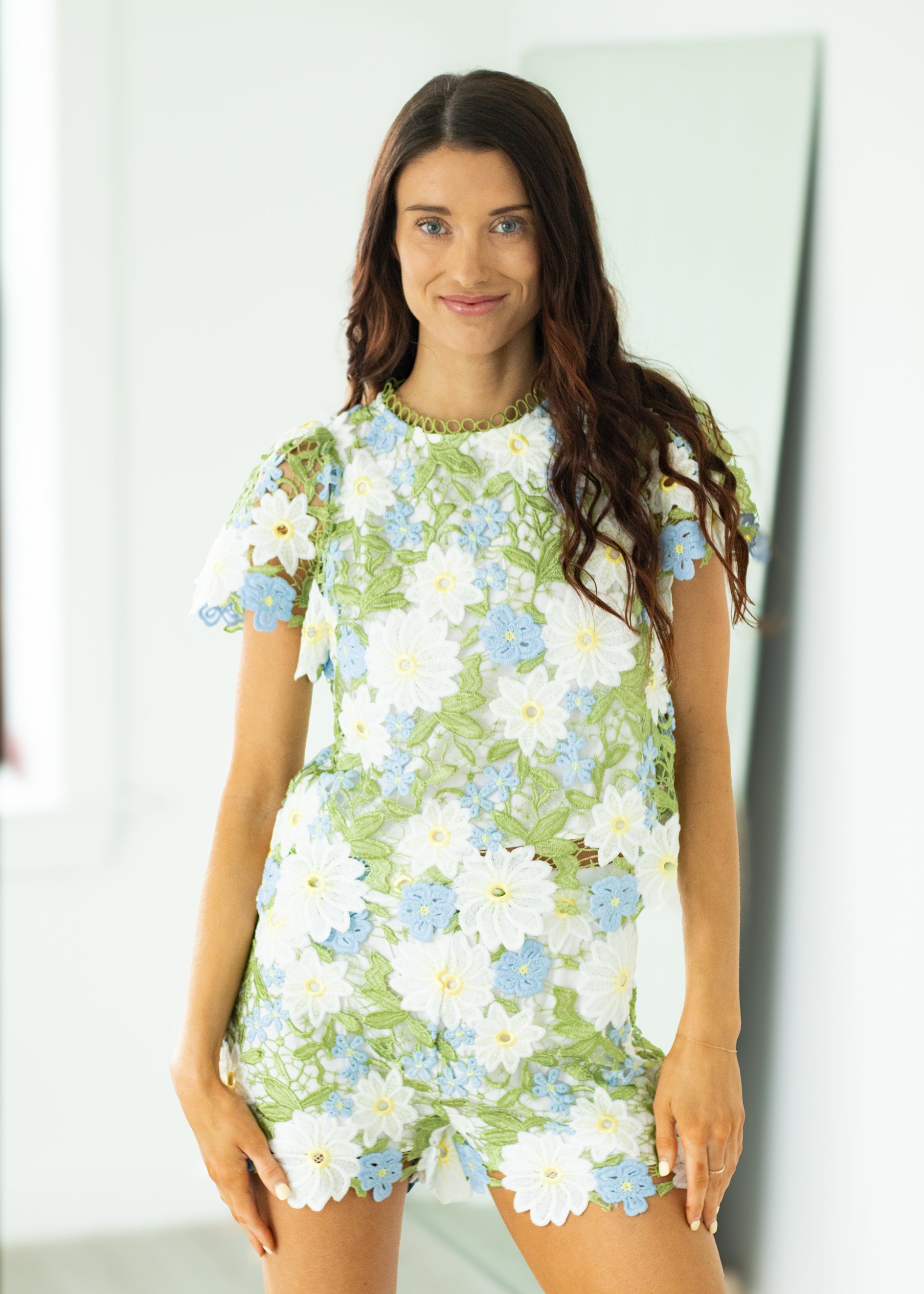 Woman wearing a floral outfit with a white background