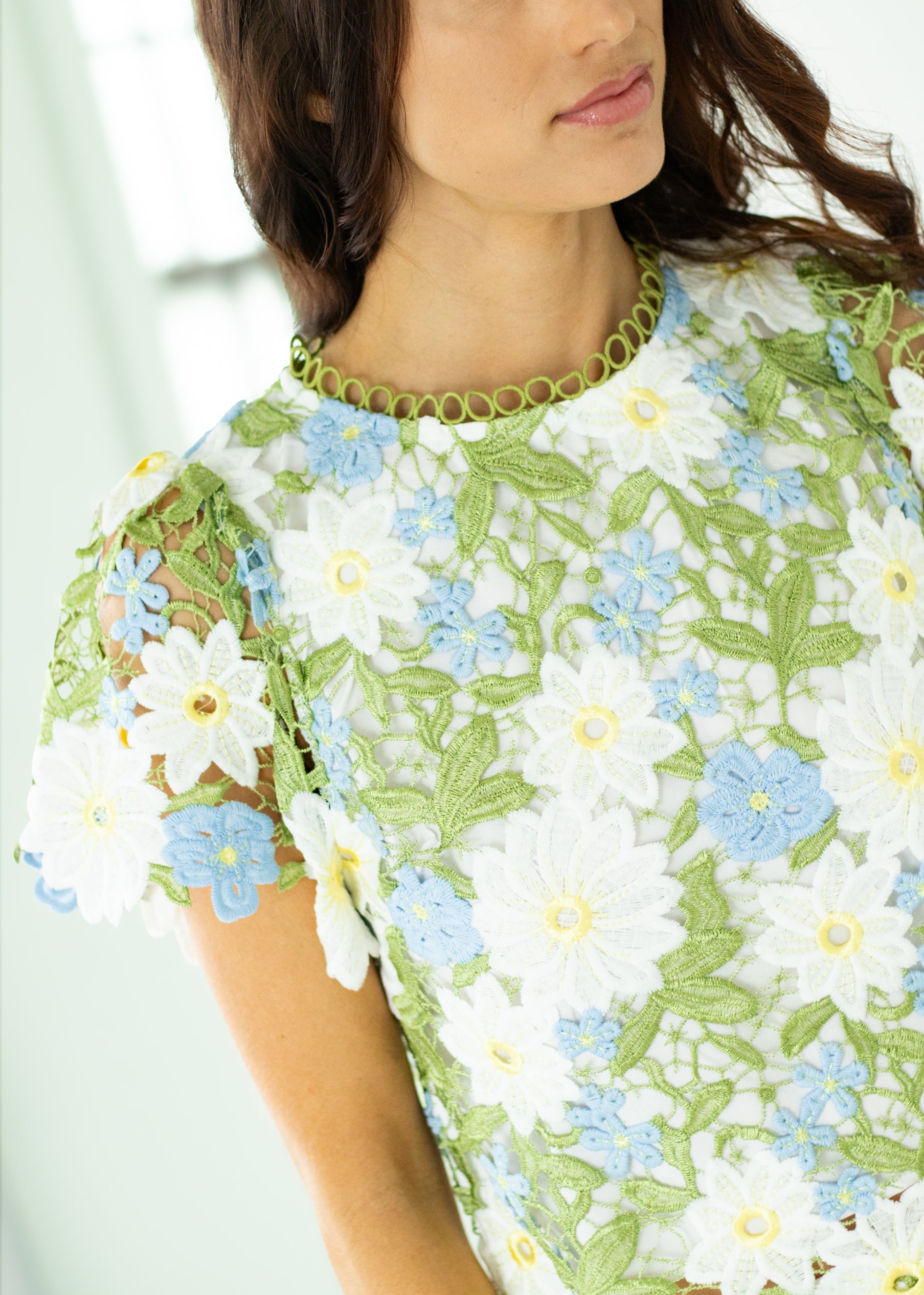 Woman wearing a floral outfit with a white background