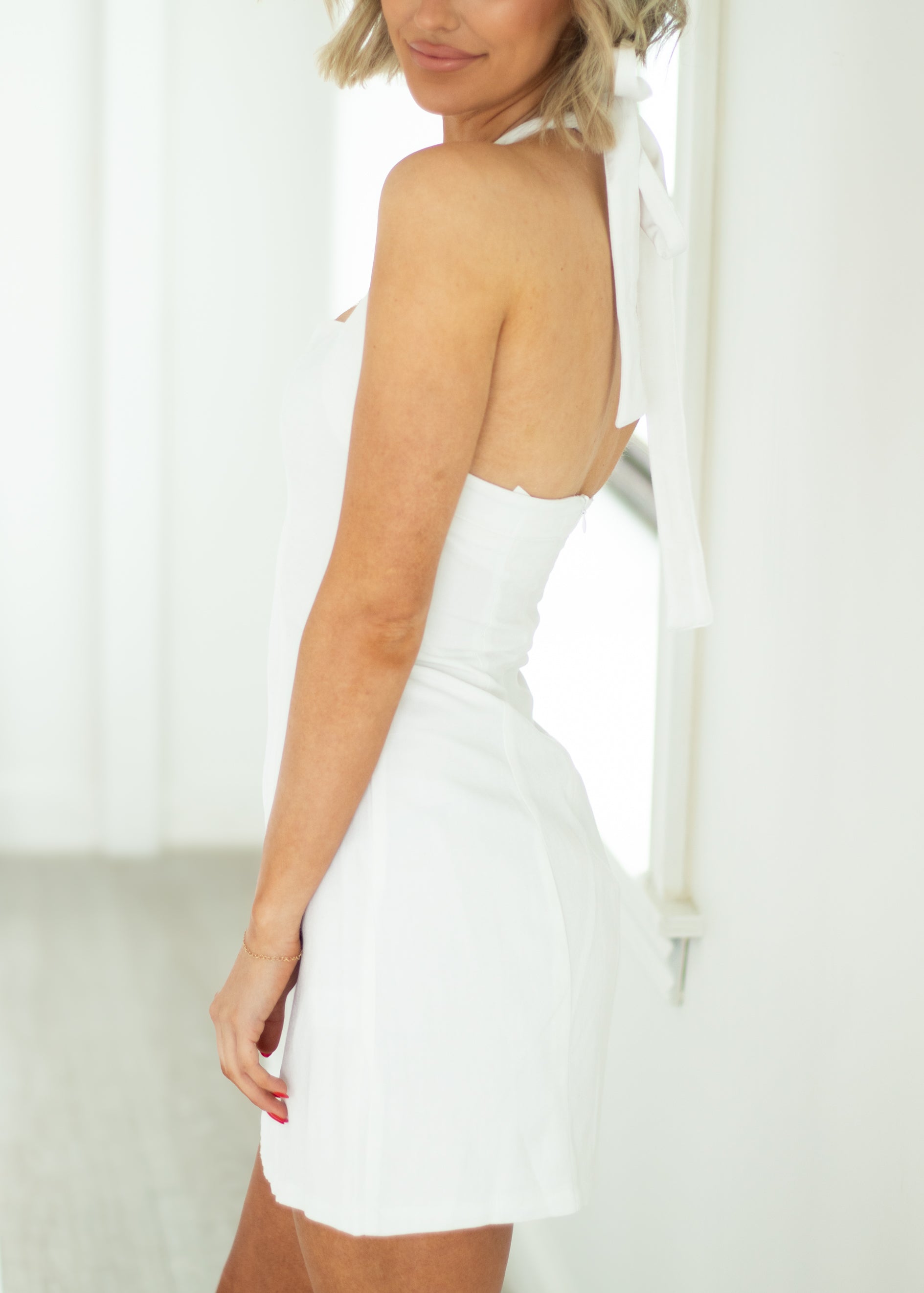 White dress worn by a person with a blurred background