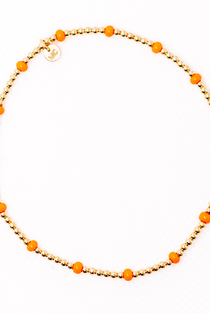gold beaded bracelet with orange