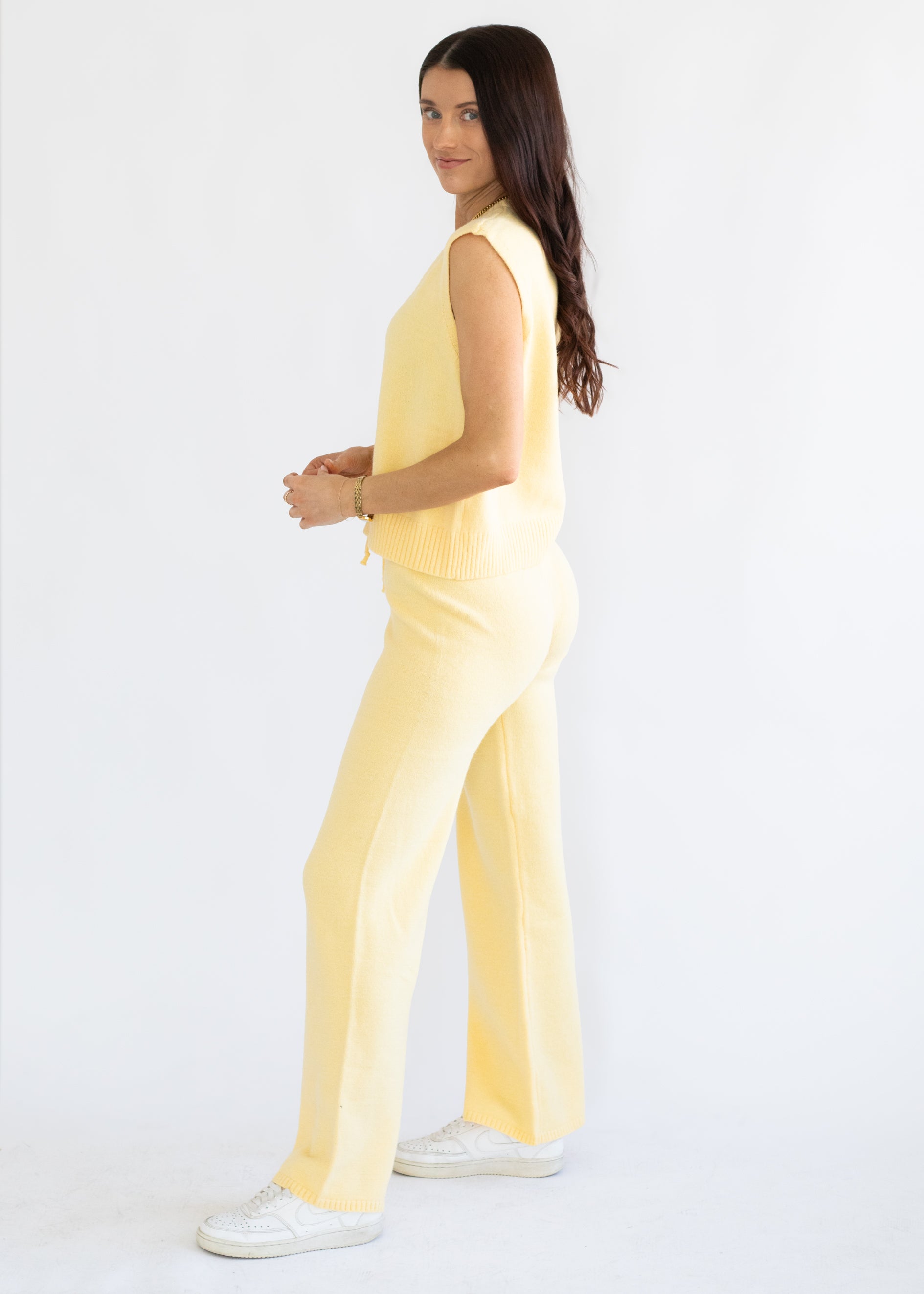 Woman wearing a yellow outfit on a white background
