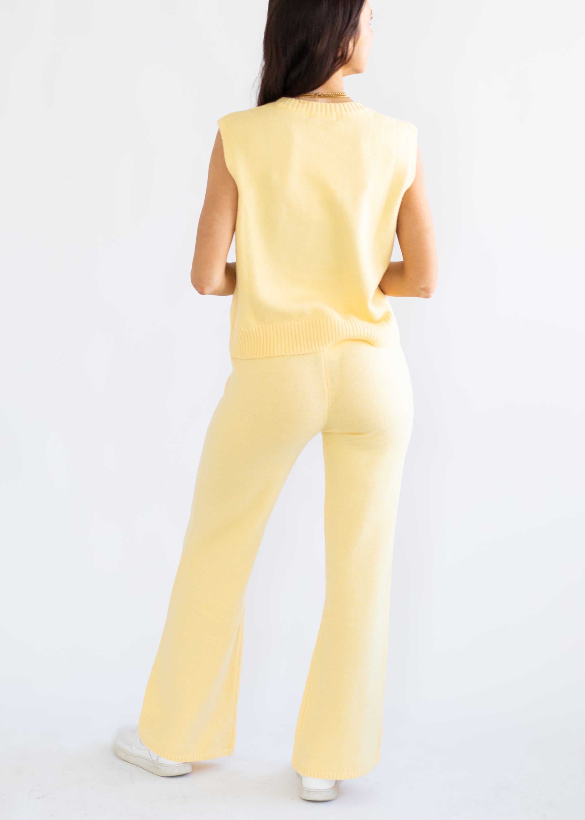 Person wearing a yellow outfit on a white background