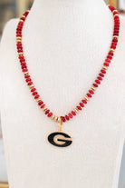 Red and gold beaded necklace with Georgia pendant