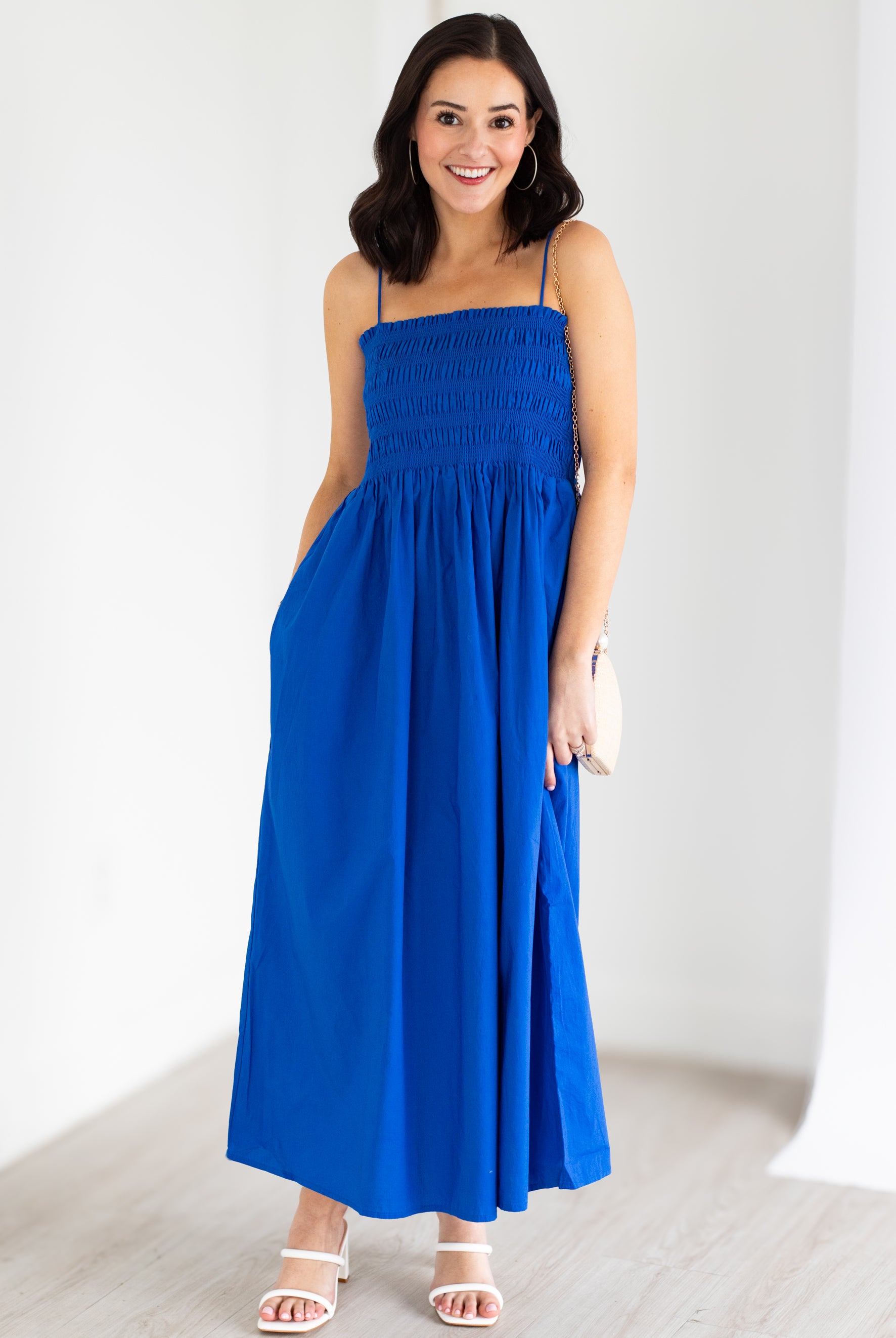 Woman wearing a blue dress against a white background