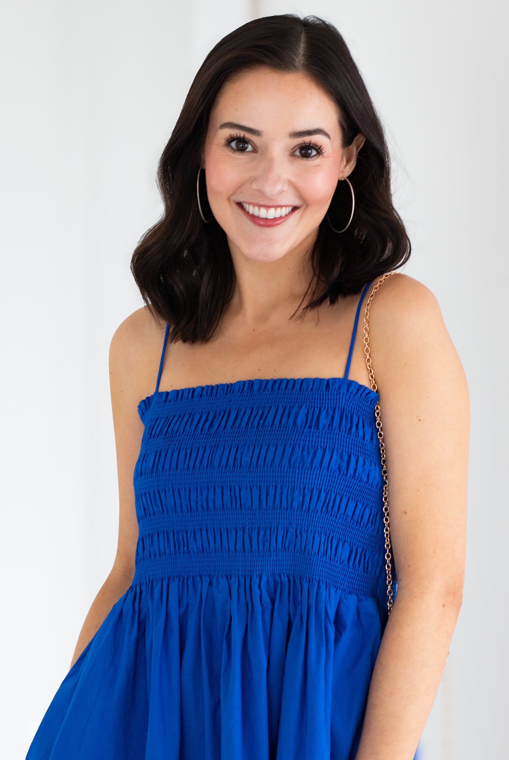 Woman wearing a blue dress against a white background