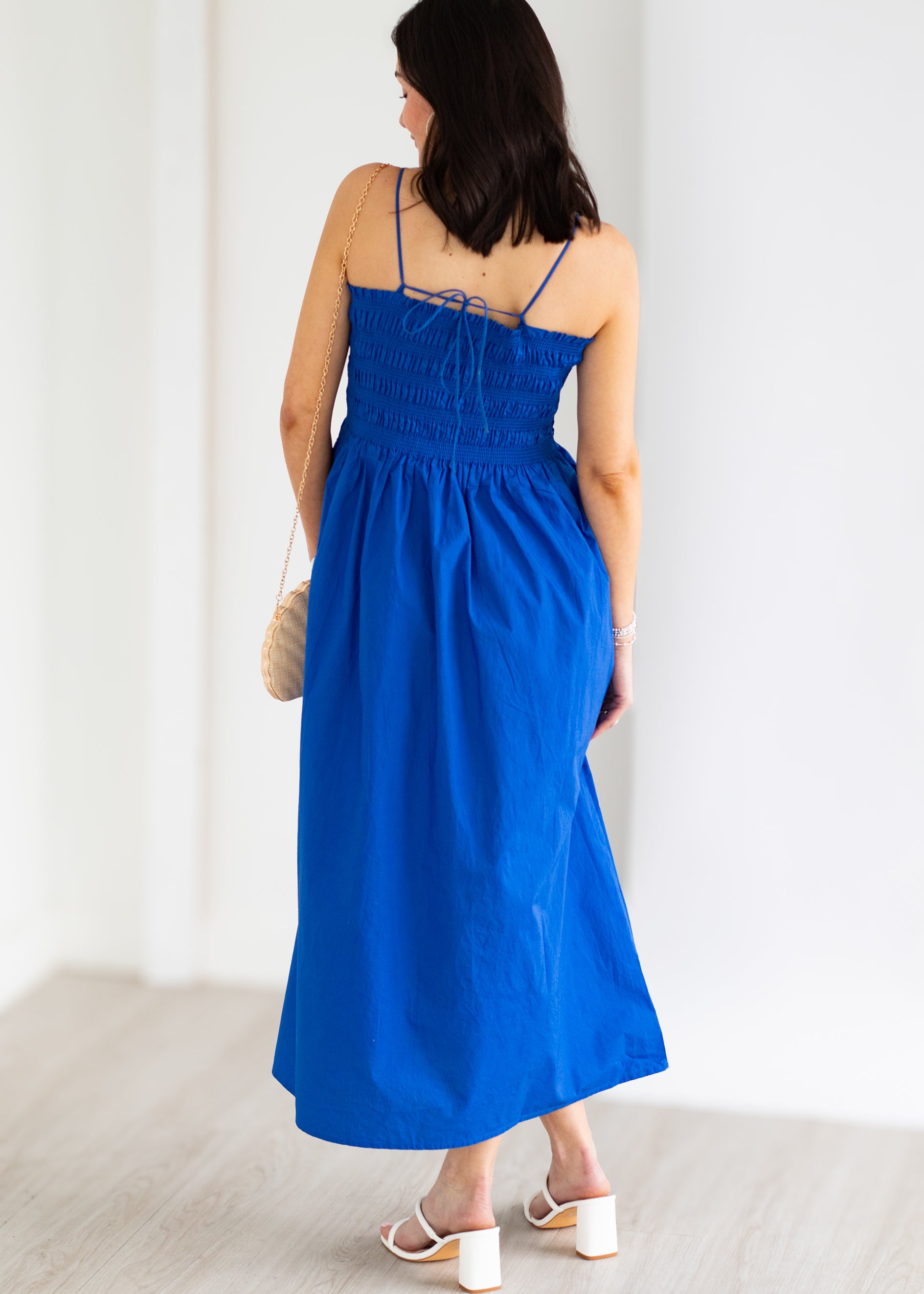 Woman wearing a blue dress against a white background