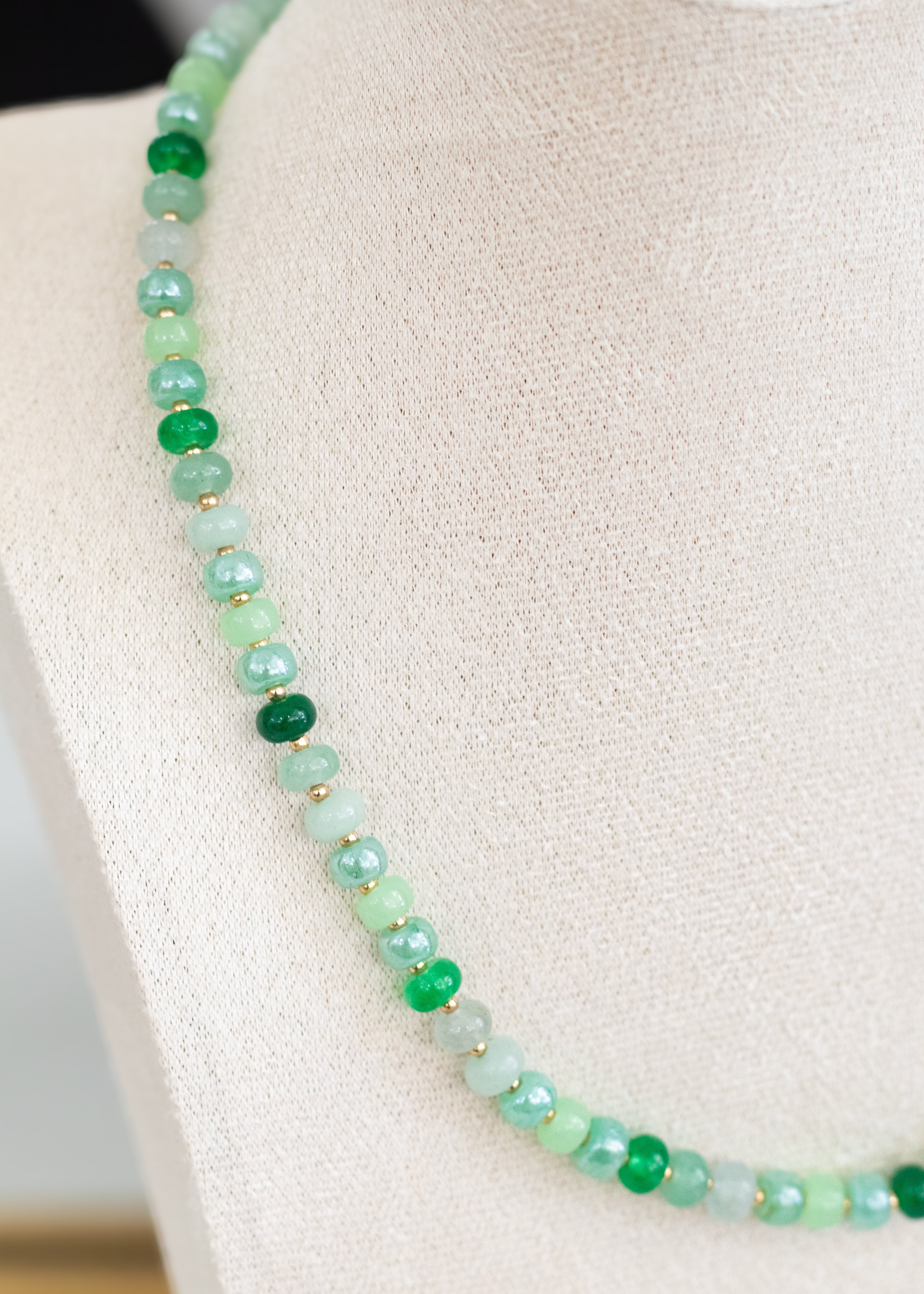 Green beaded necklace on a mannequin bust