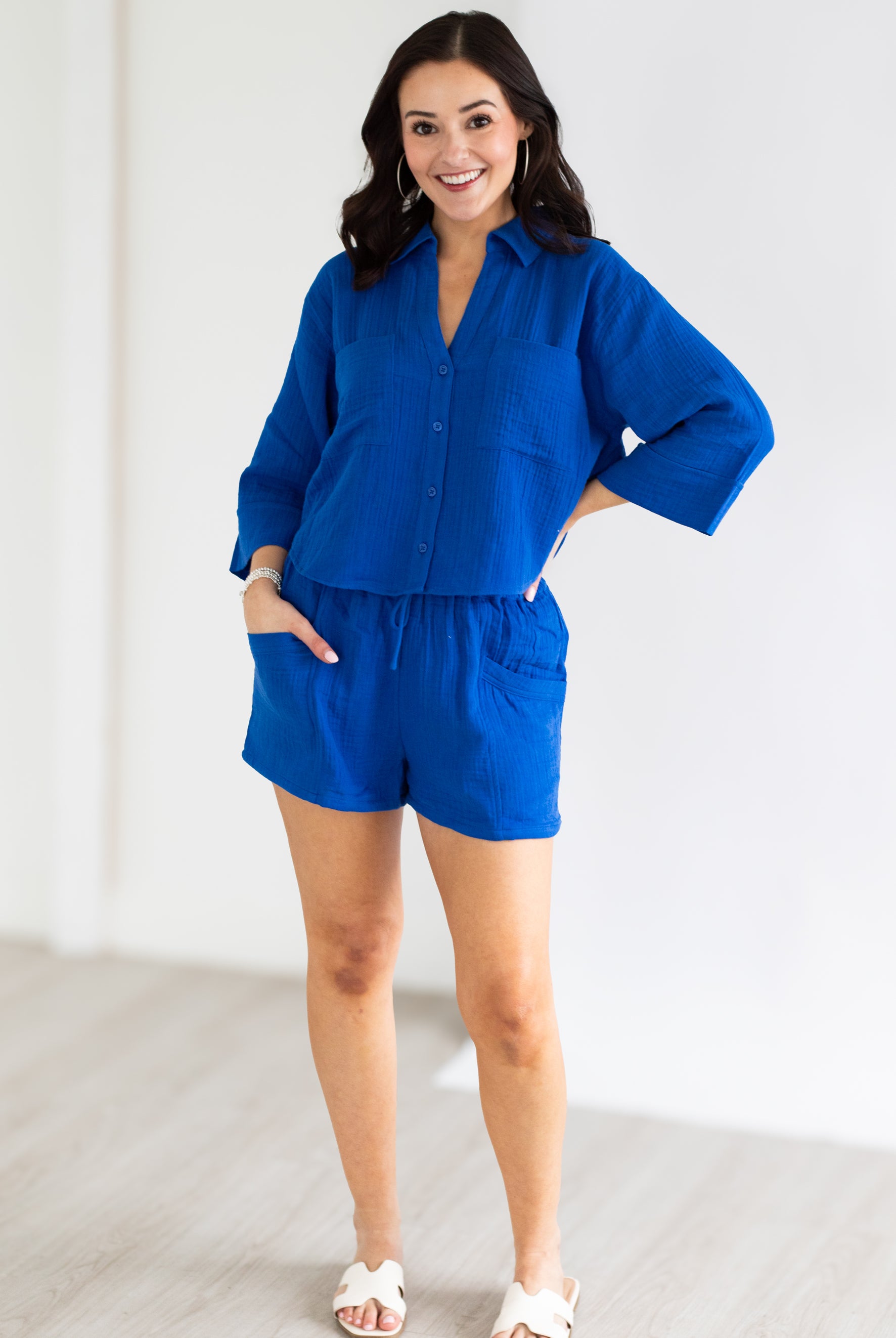 Woman wearing a blue outfit with a white background