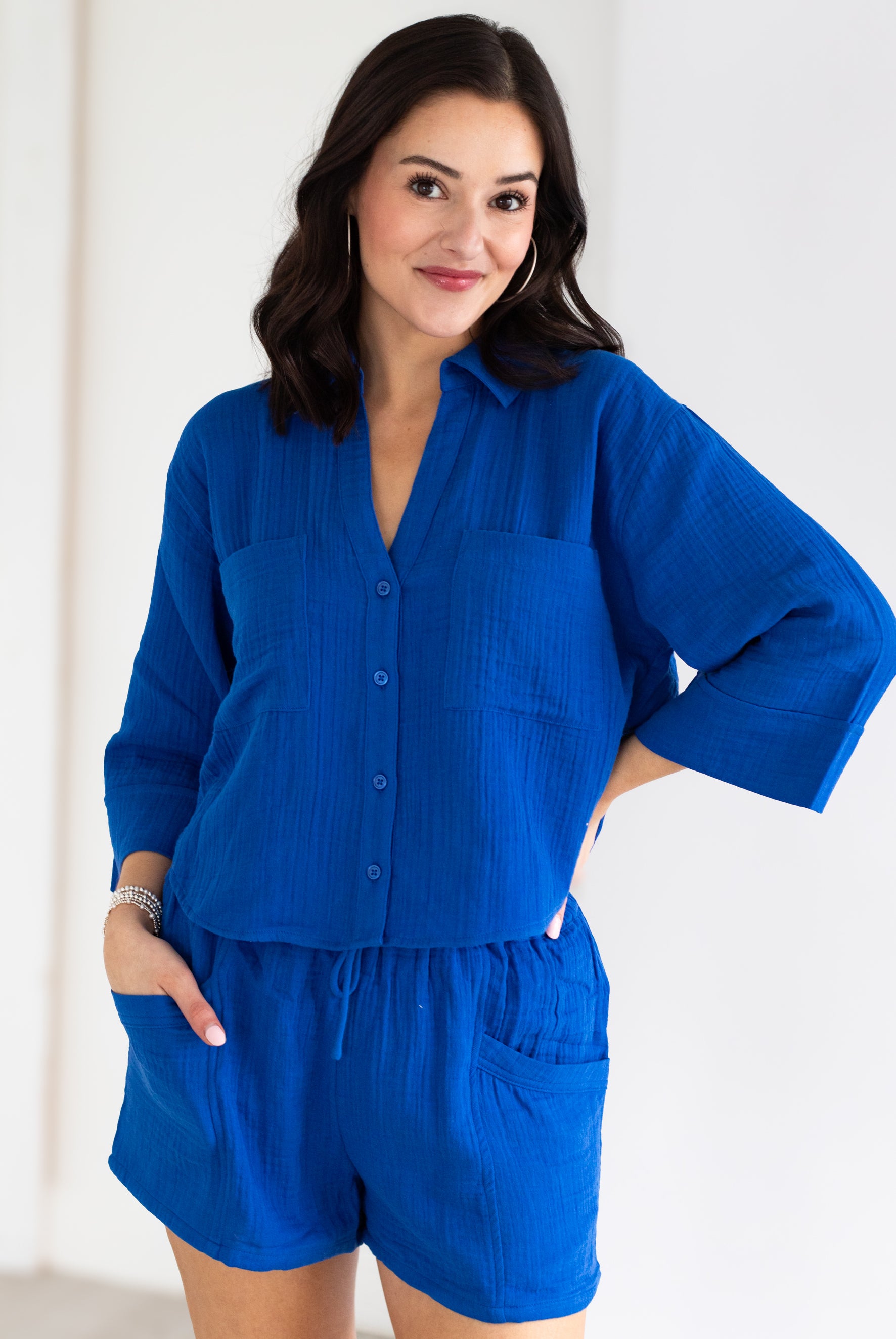 Woman wearing a blue outfit with a white background