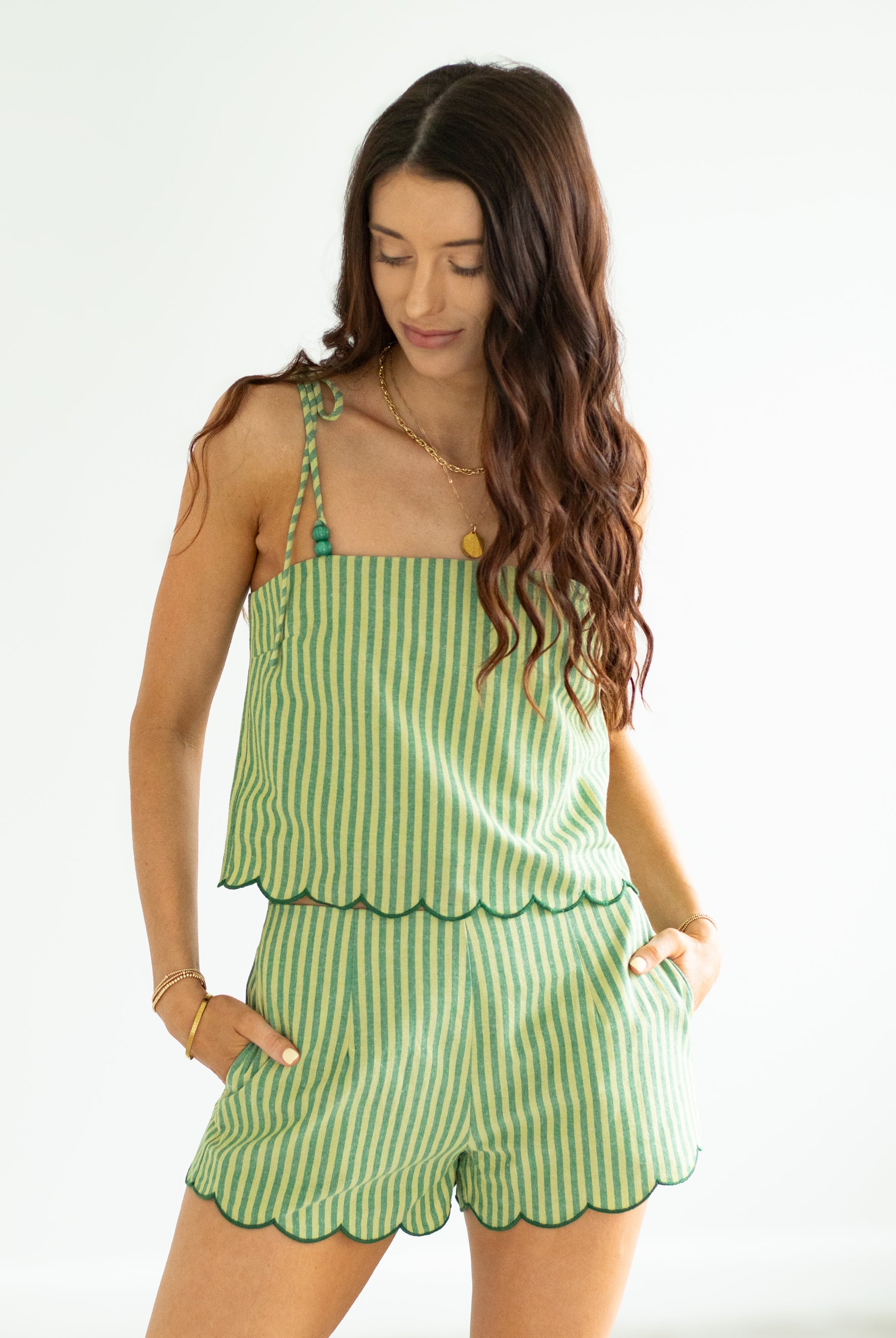 Woman wearing a green striped set on a white background