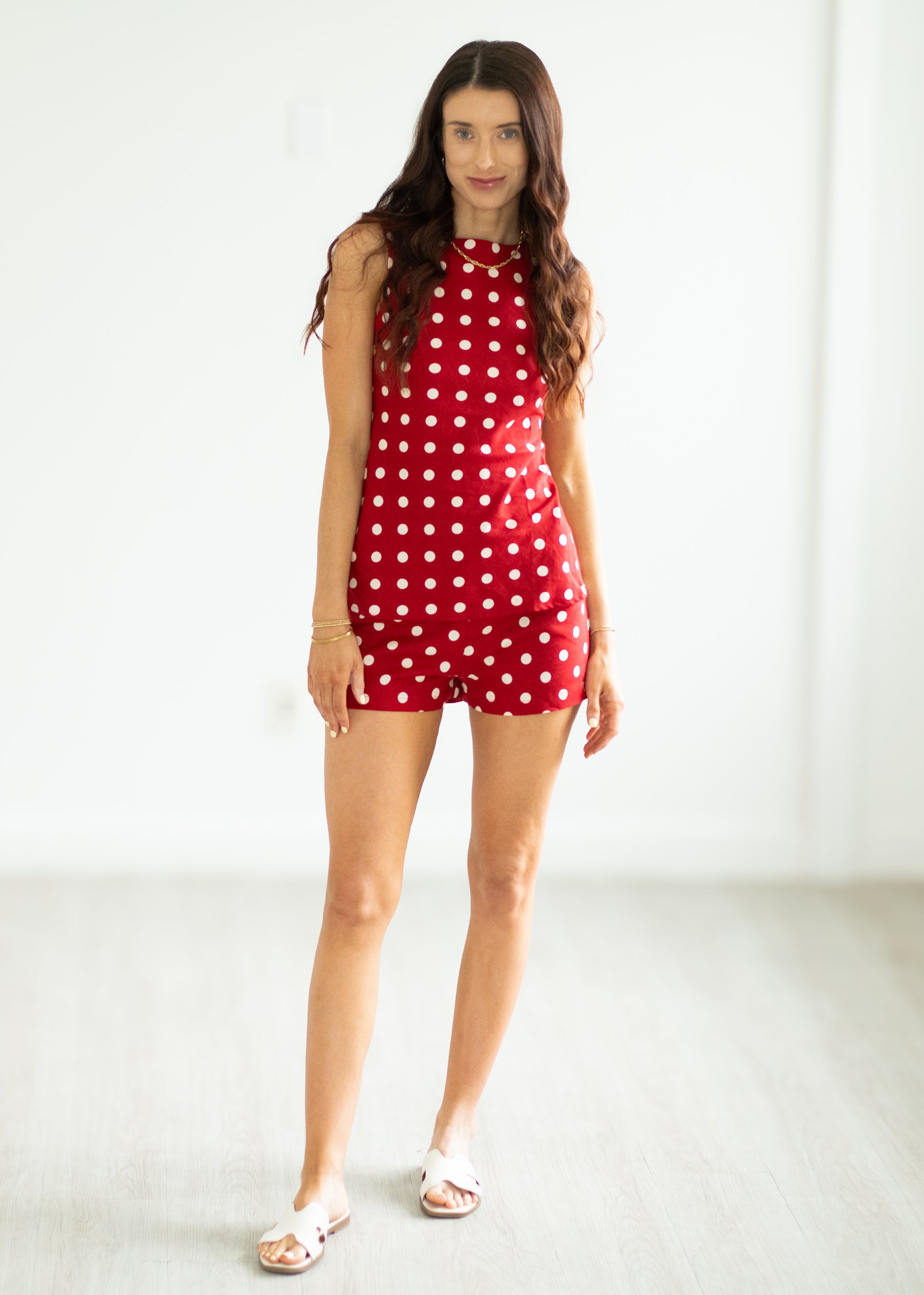 Woman wearing a red polka dot set on a white background