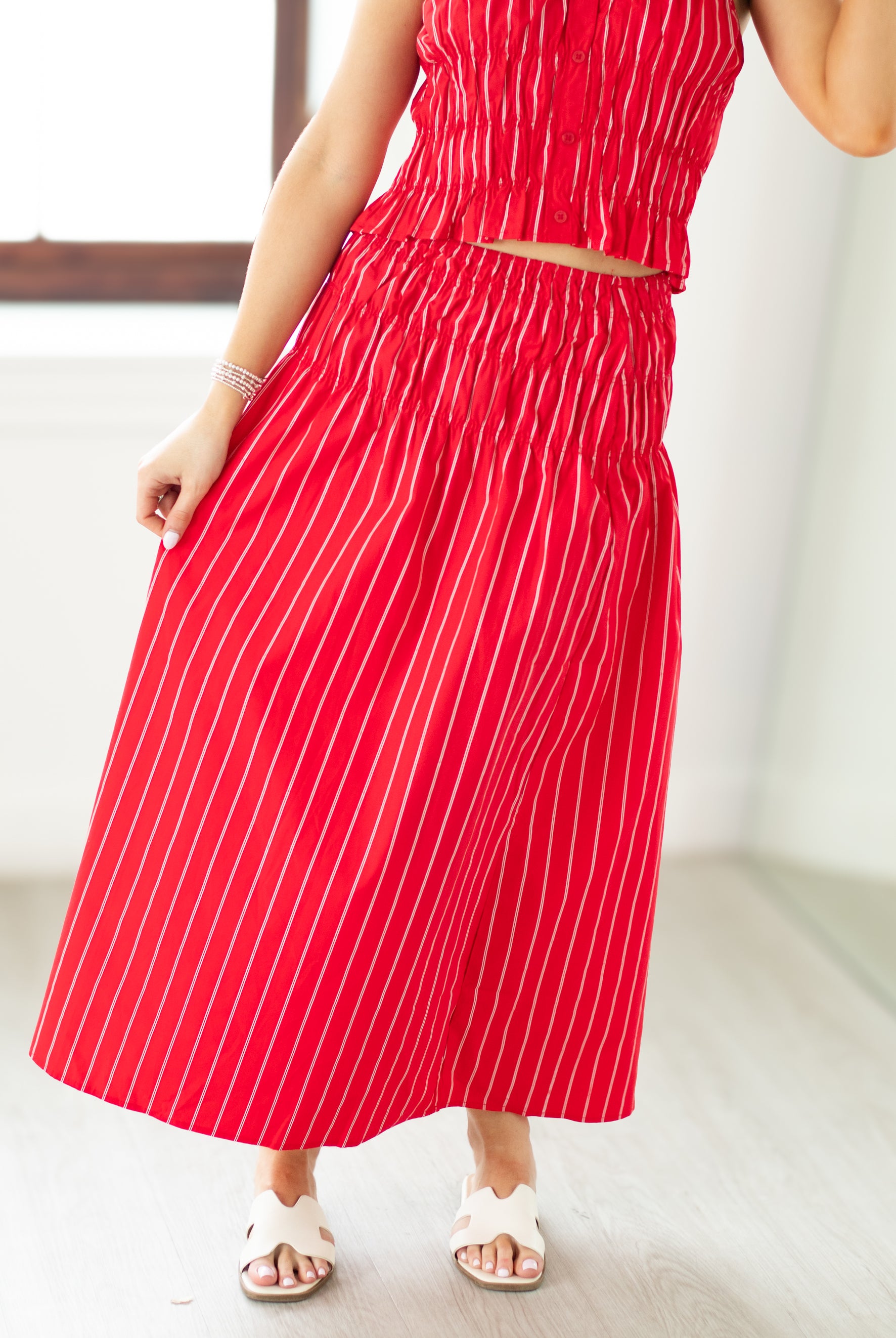 Red and white striped dress worn by a person indoors.