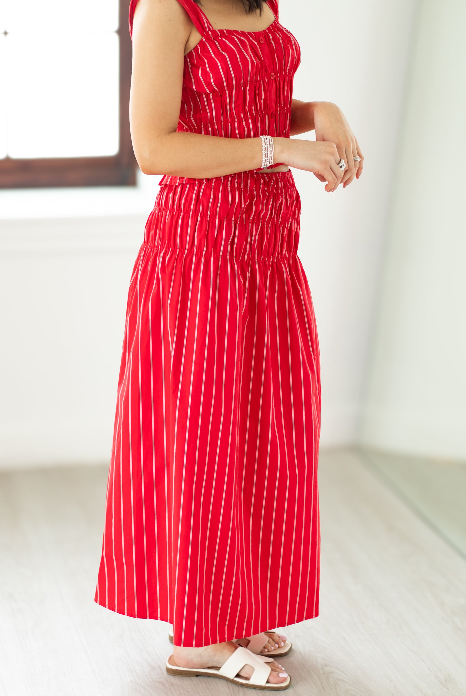 Red striped dress worn by a person on a white background