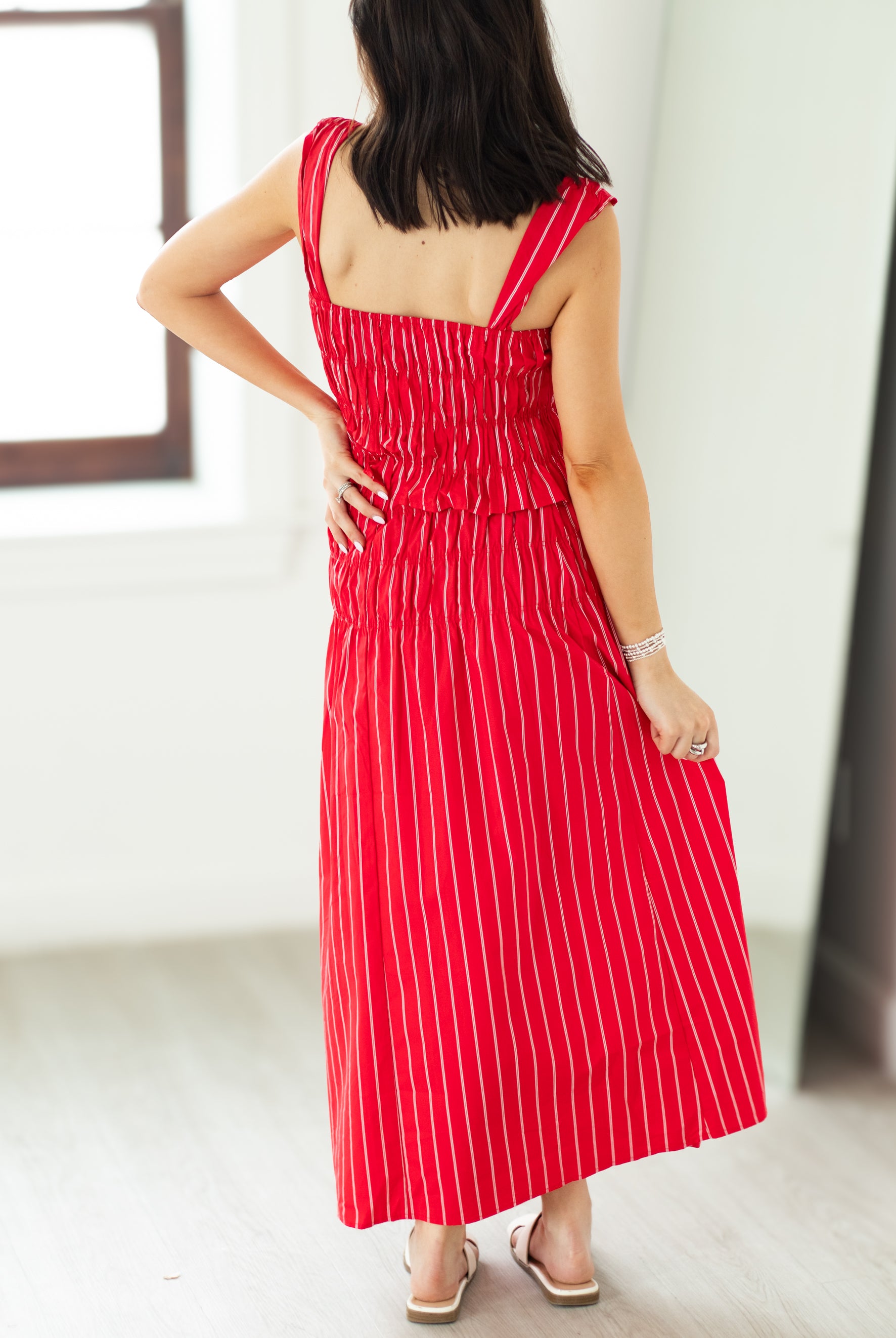 Woman wearing a red and white striped dress with a blurred background