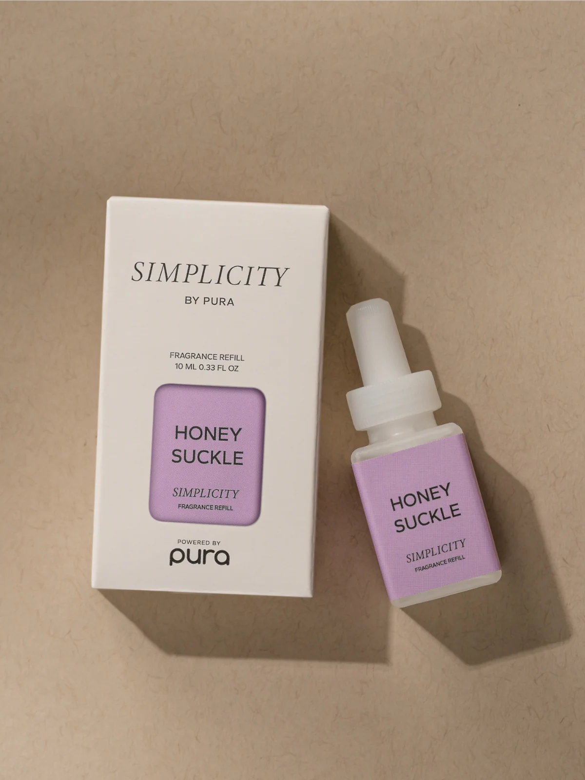 Simplicity by Pura Honey Suckle refill bottle and packaging on a beige background