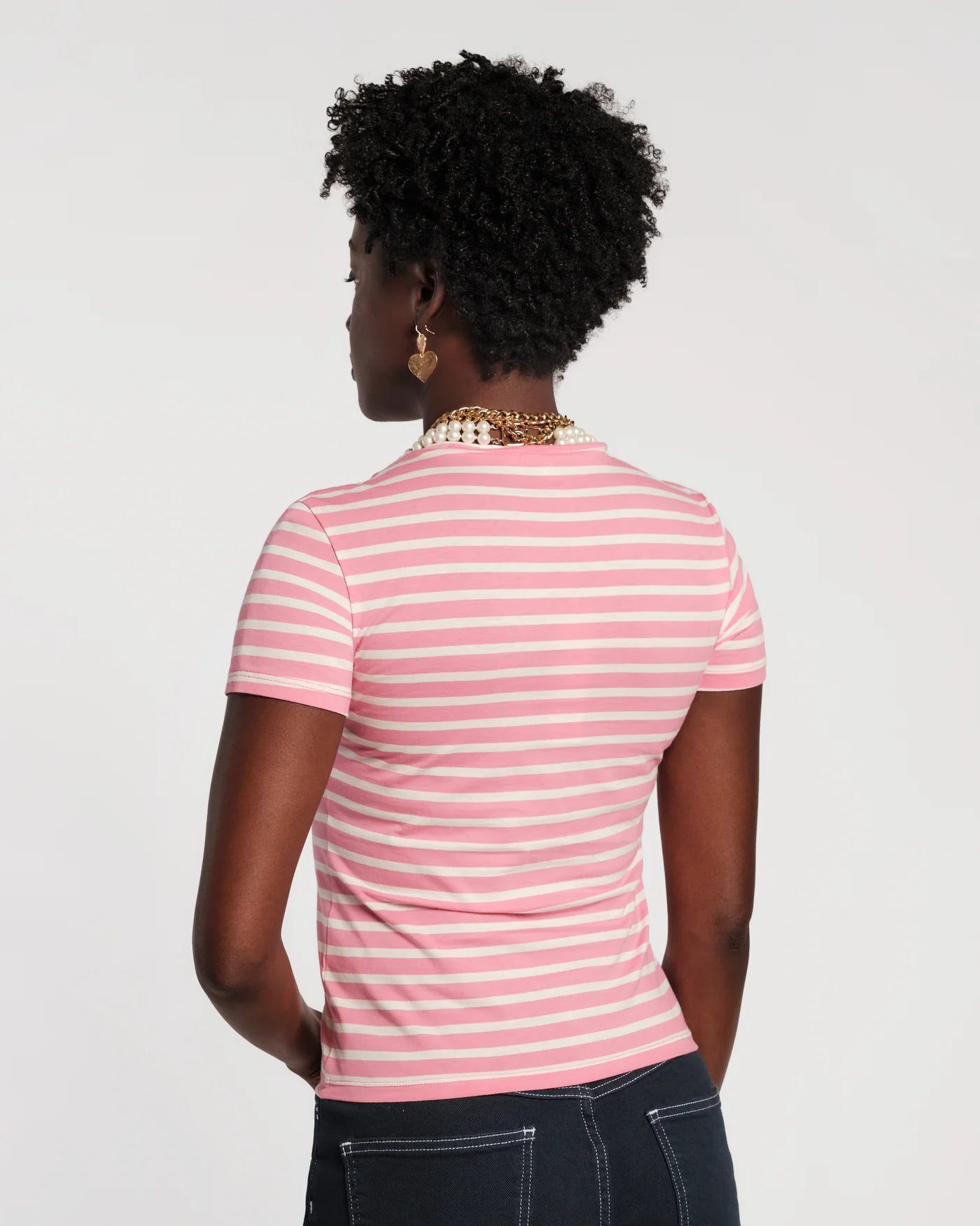 Person wearing a pink and white striped shirt on a plain background