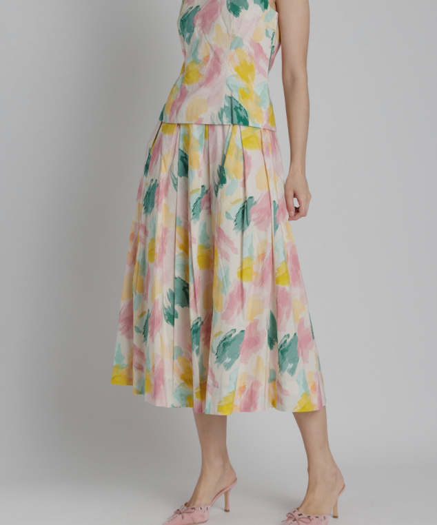 Woman wearing a floral dress on a plain background
