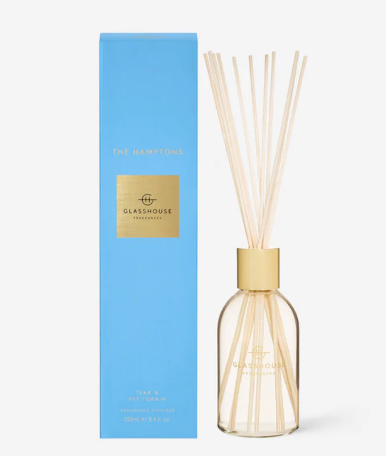 Diffuser bottle with gold cap and 'Glasshouse' branding next to a blue box on a white background