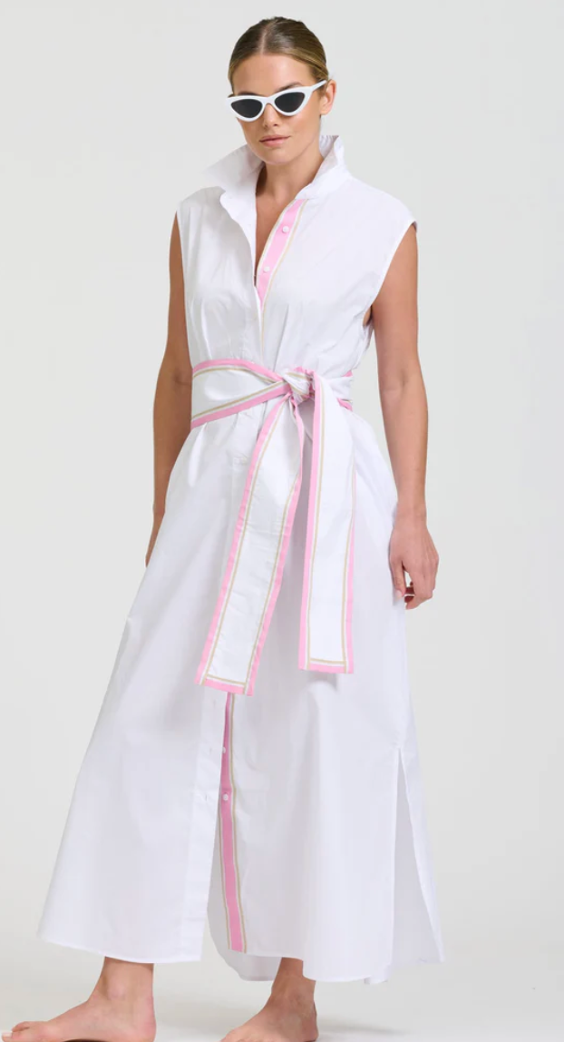 Woman wearing a white sleeveless dress with pink trim on a white background