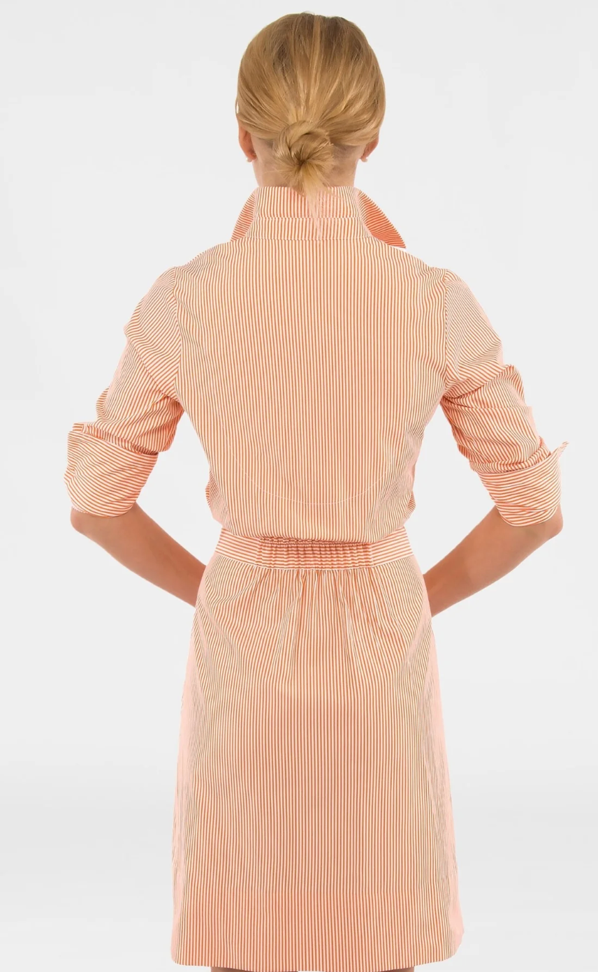 Woman wearing a beige ribbed dress with a white background
