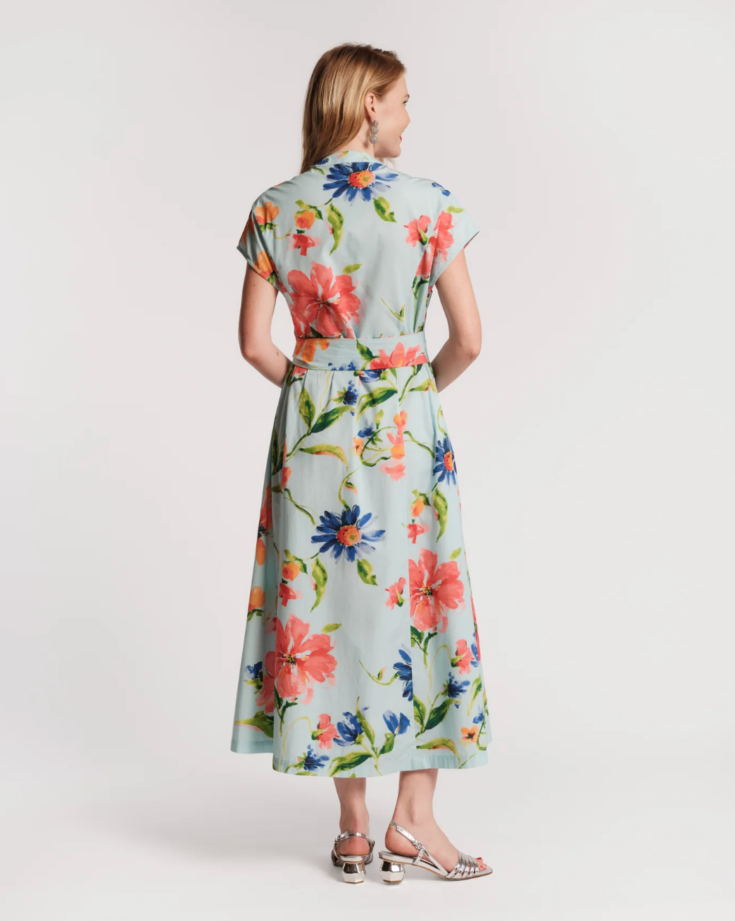 Woman wearing a floral dress on a white background